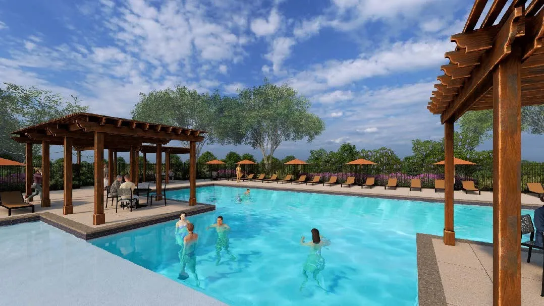Expansive swimming pool area featuring a rectangular pool, a built-in pergola with seating, multiple lounge chairs, and scattered umbrellas