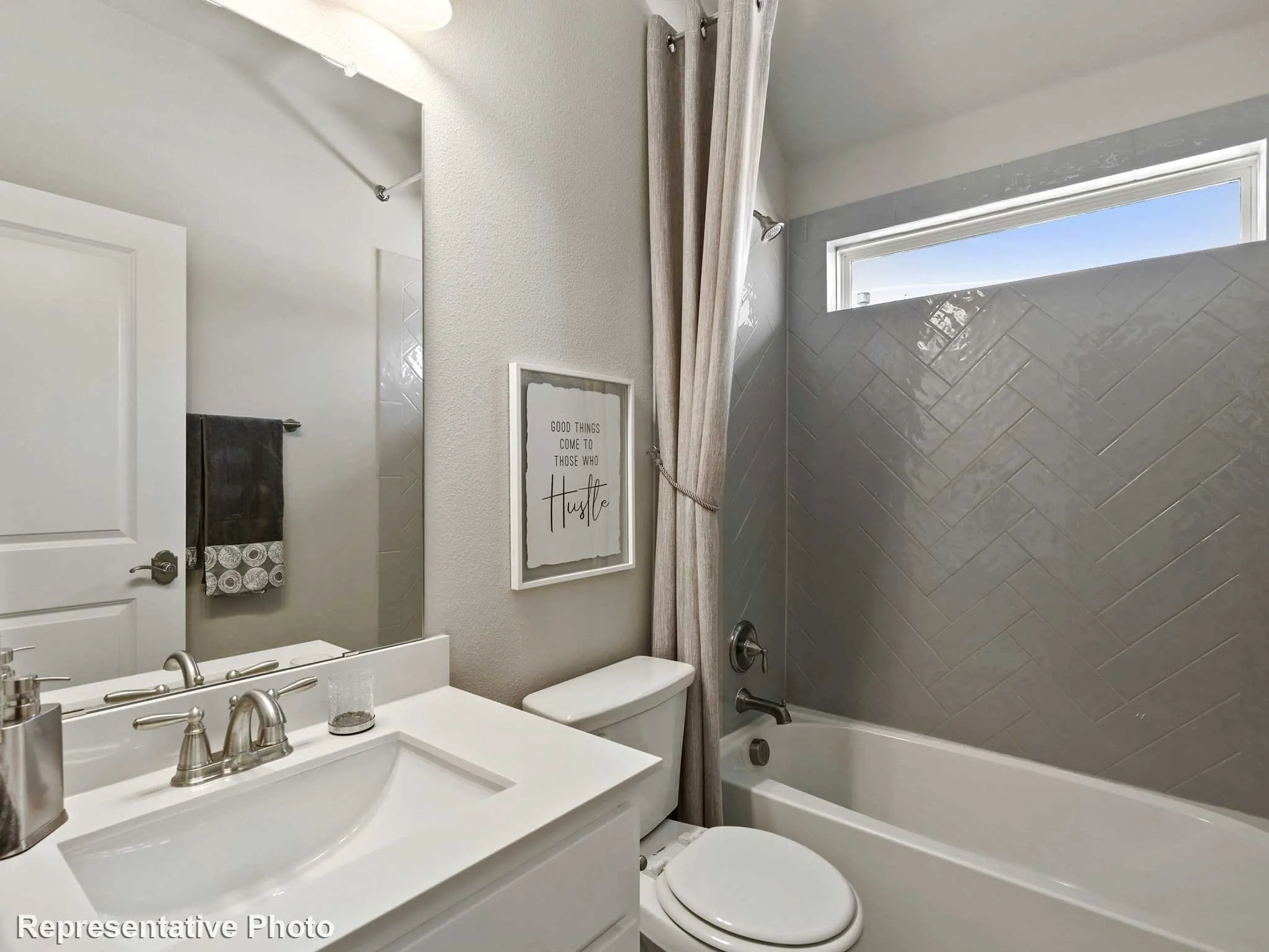 Bathroom featuring a white vanity with an undermount sink, brushed nickel faucet, and a large mirror