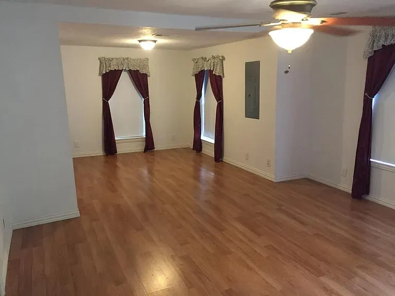 Expansive room featuring wood-finish flooring throughout
