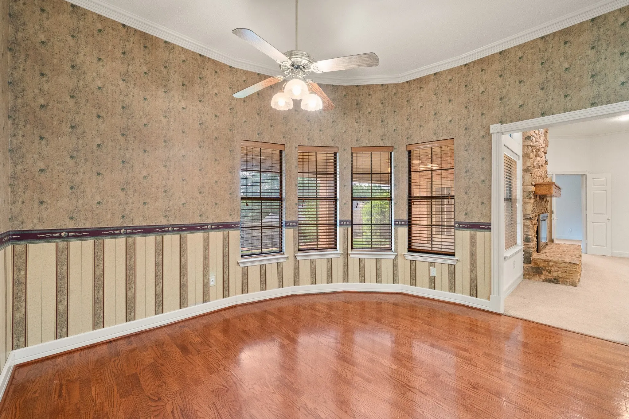 Bay window alcove featuring rich wood-finish flooring
