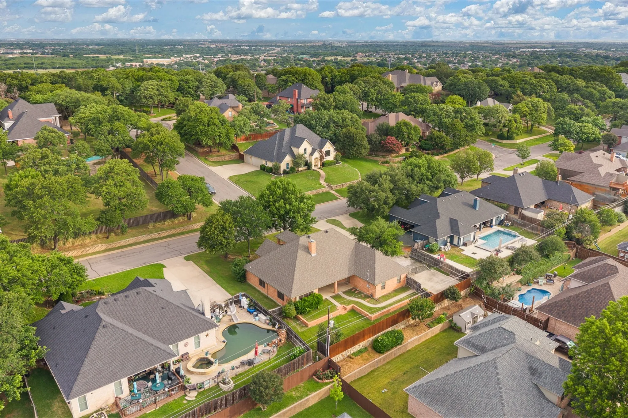 Aerial perspective of a residential neighborhood featuring established homes with varied architectural styles