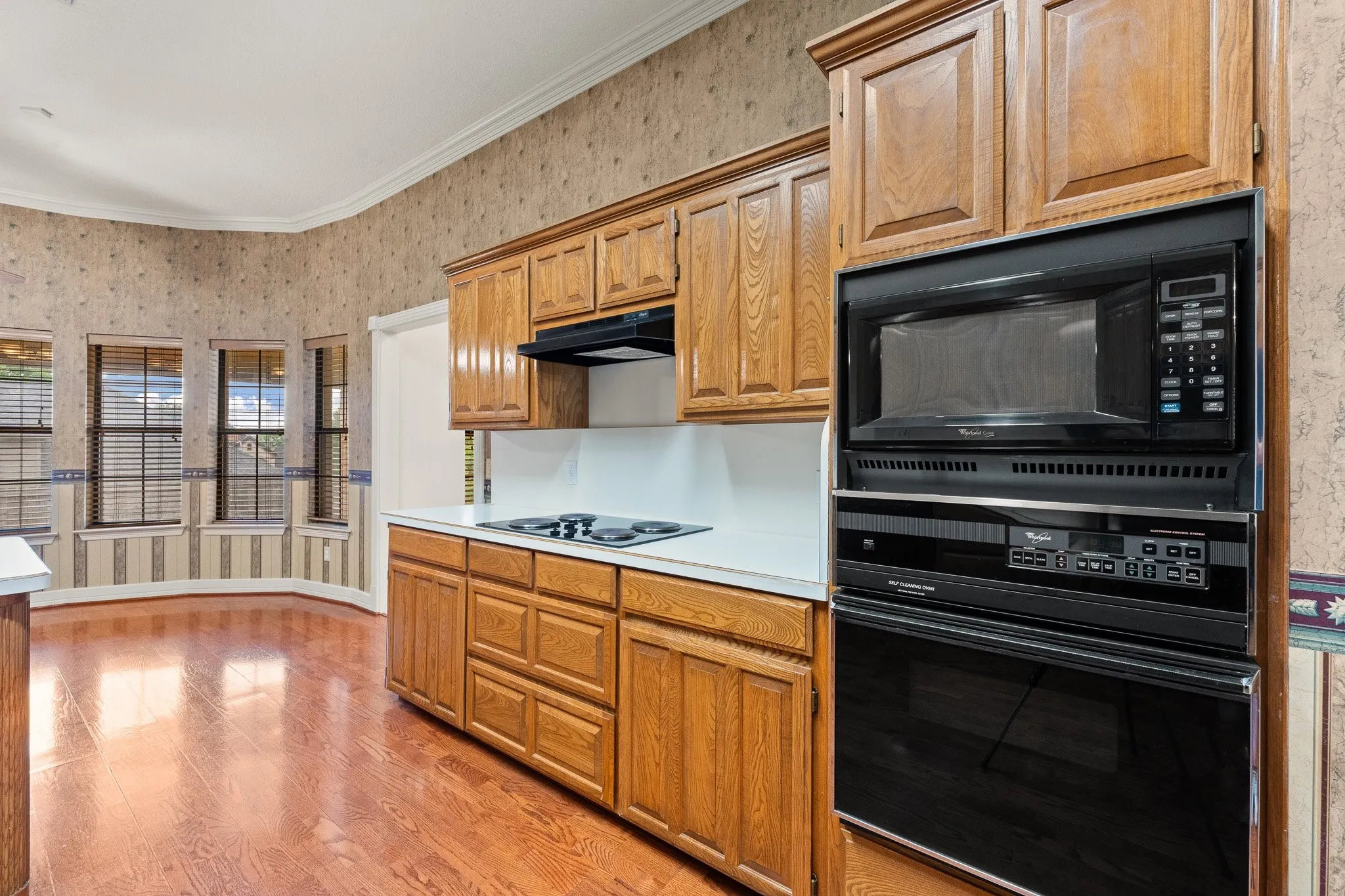 Kitchen featuring light wood cabinetry and integrated appliances
