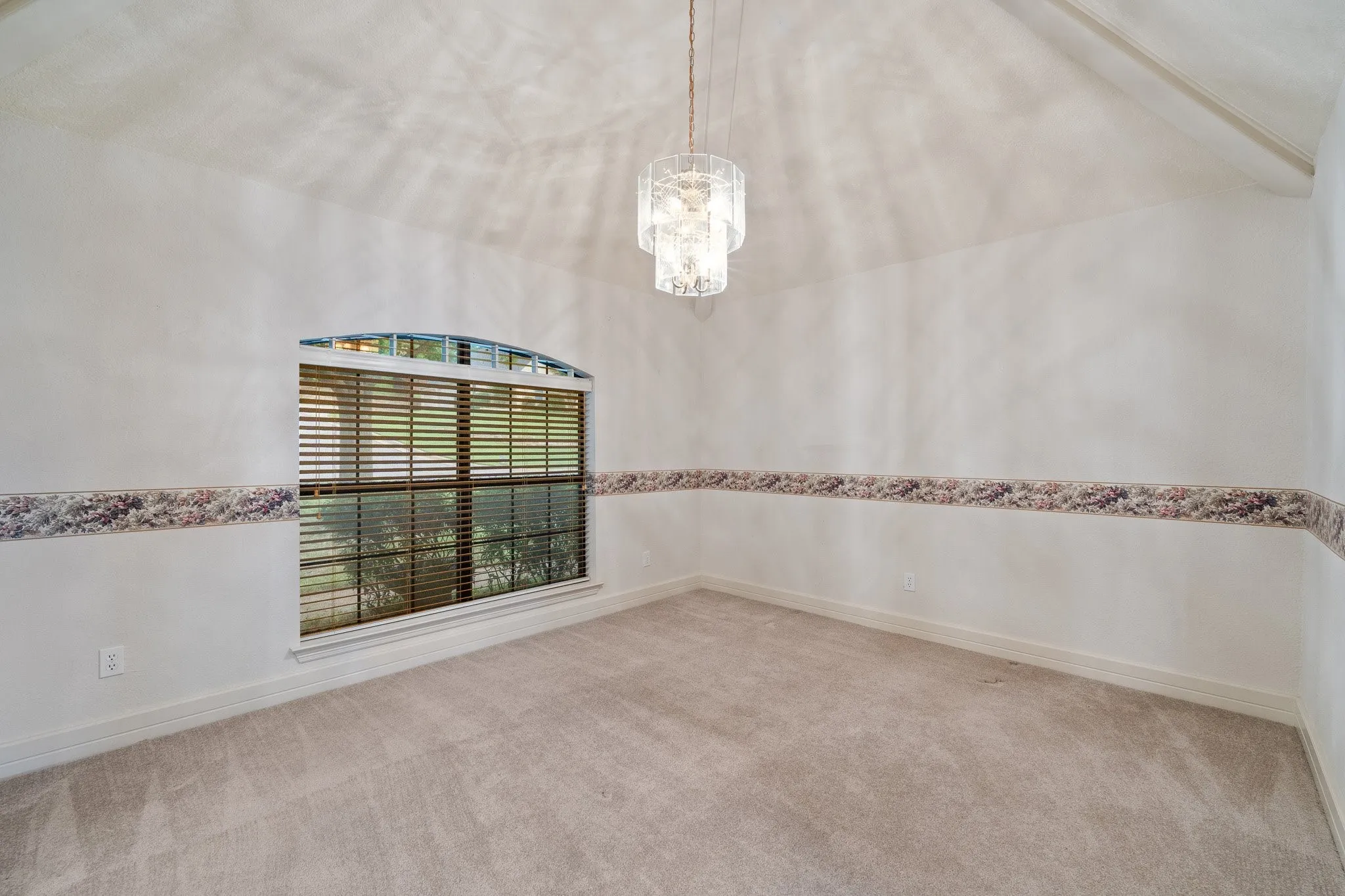 Formal dining space with vaulted ceiling