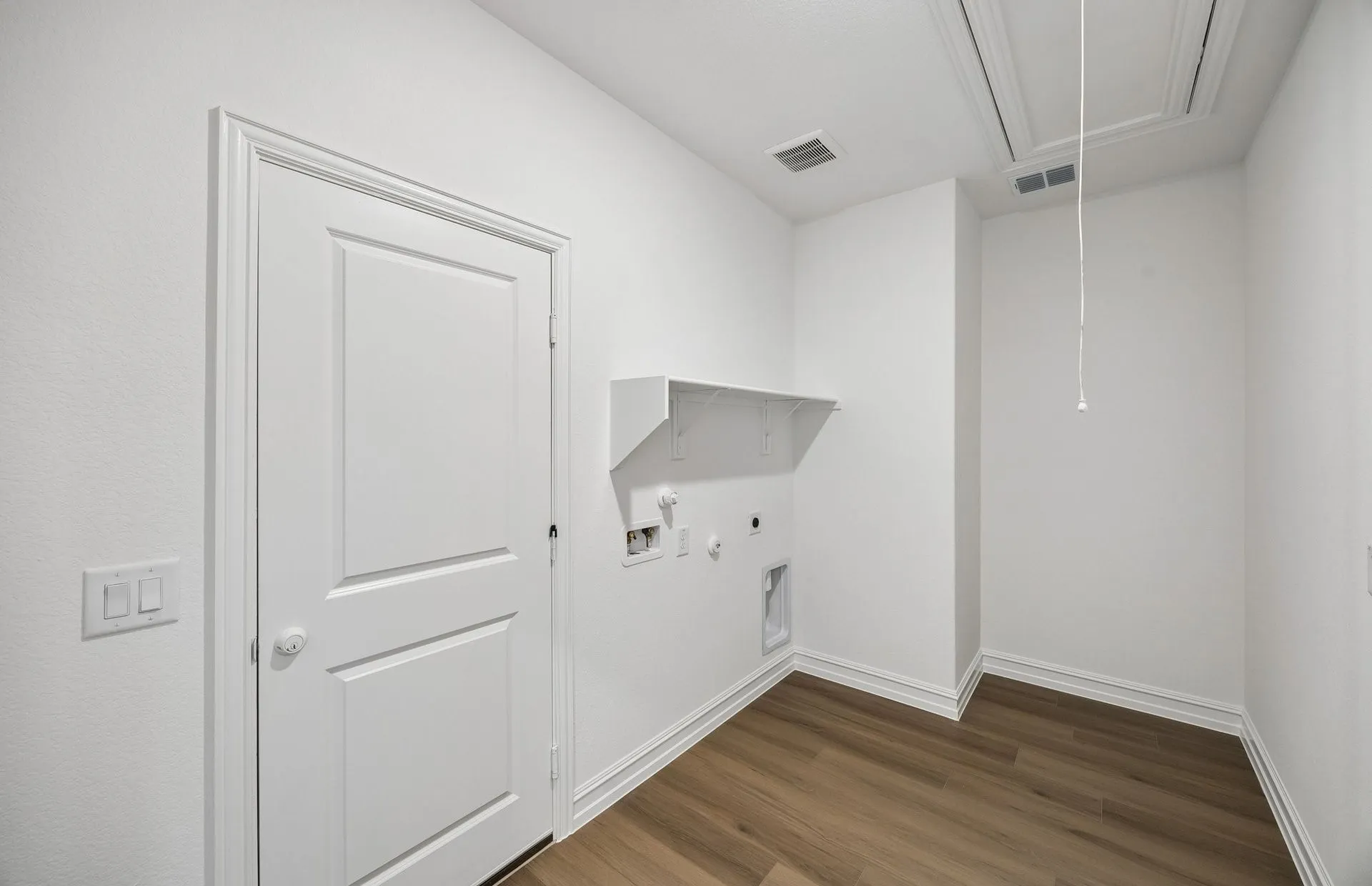 Laundry room with built-in shelving