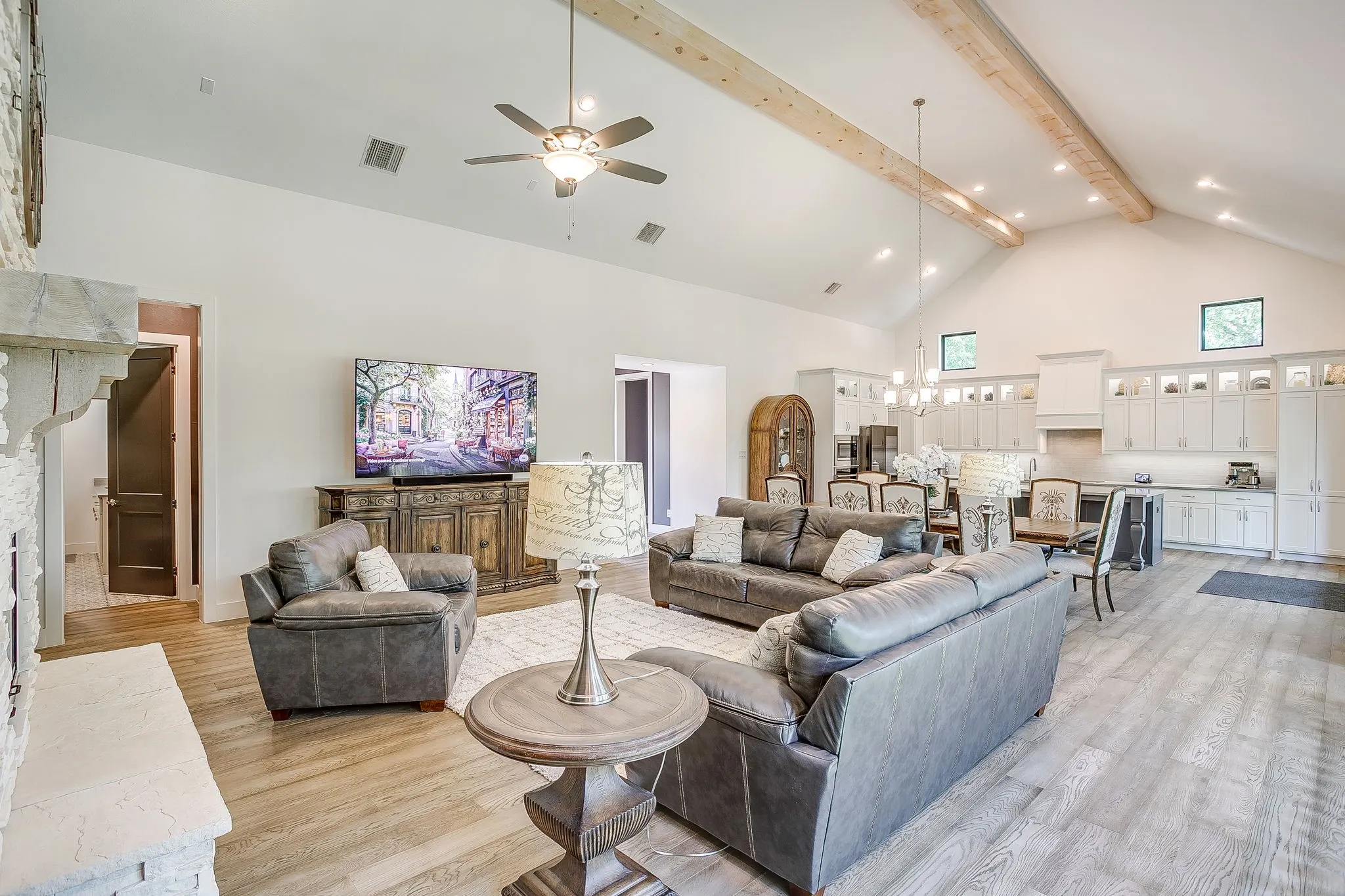 Living room with wood beams & wood flooring.