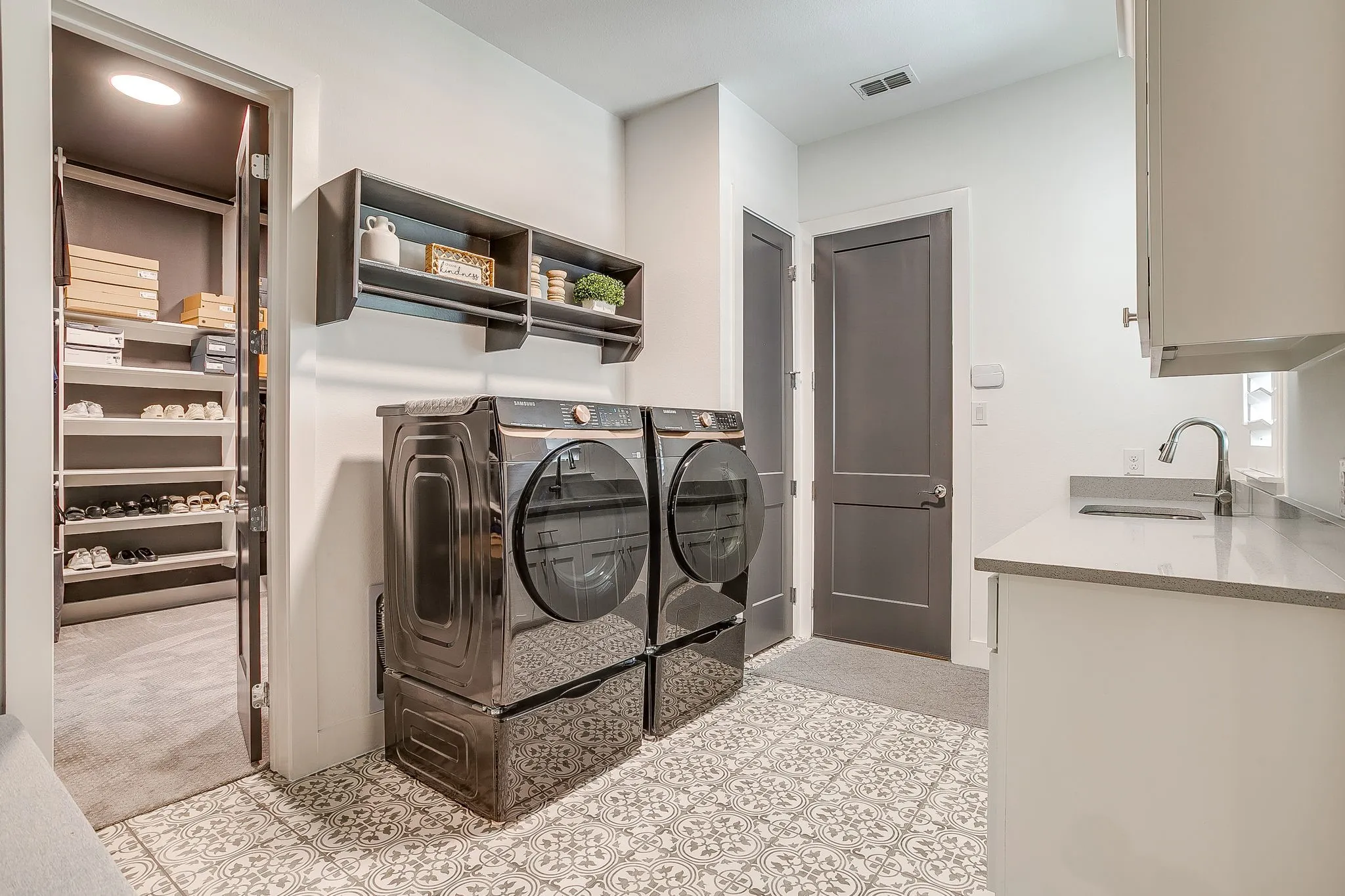 Large utility room with sink & countertops.