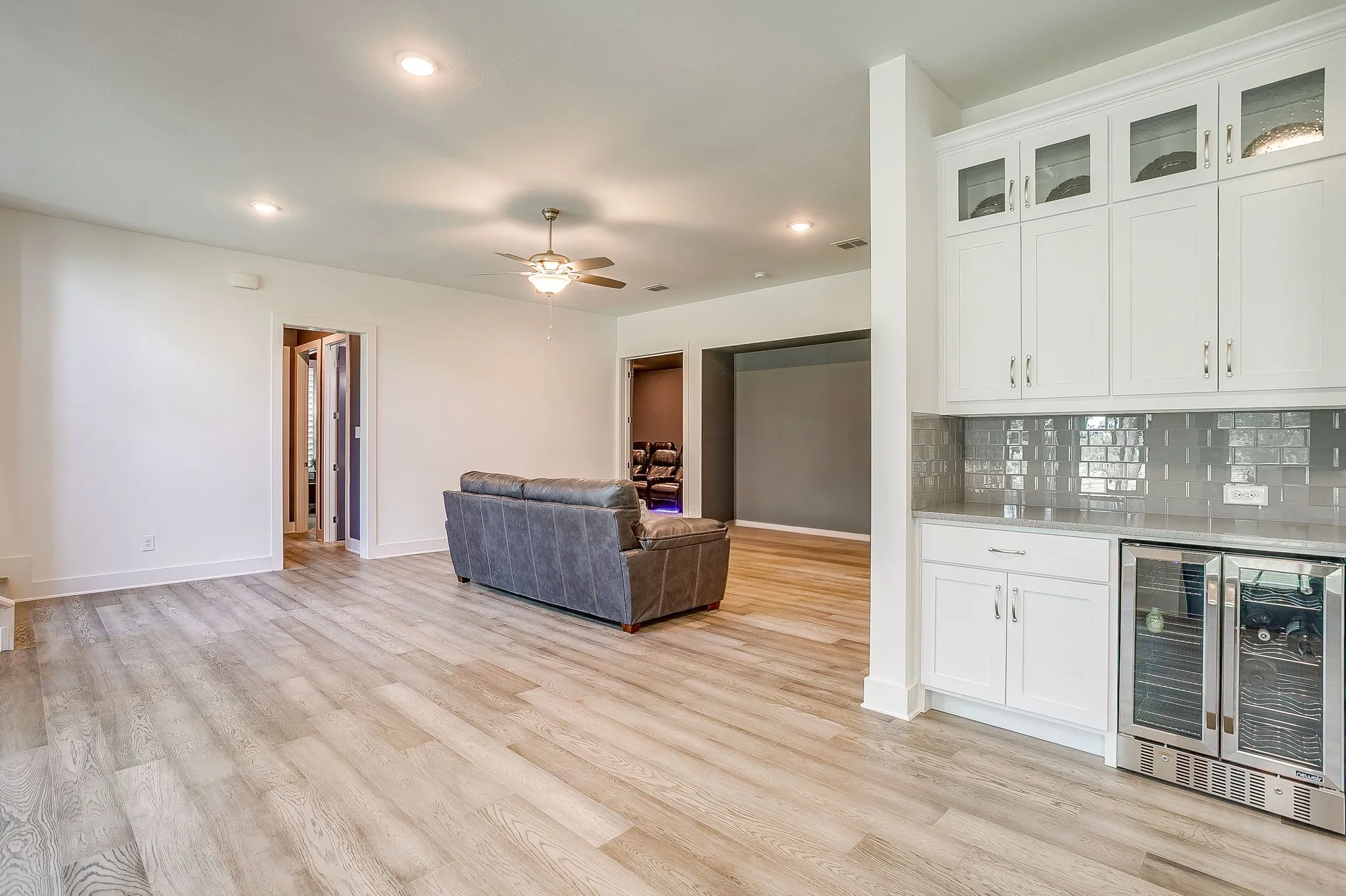 Game Room with wet bar that includes wine fridge & built-in cabinets.