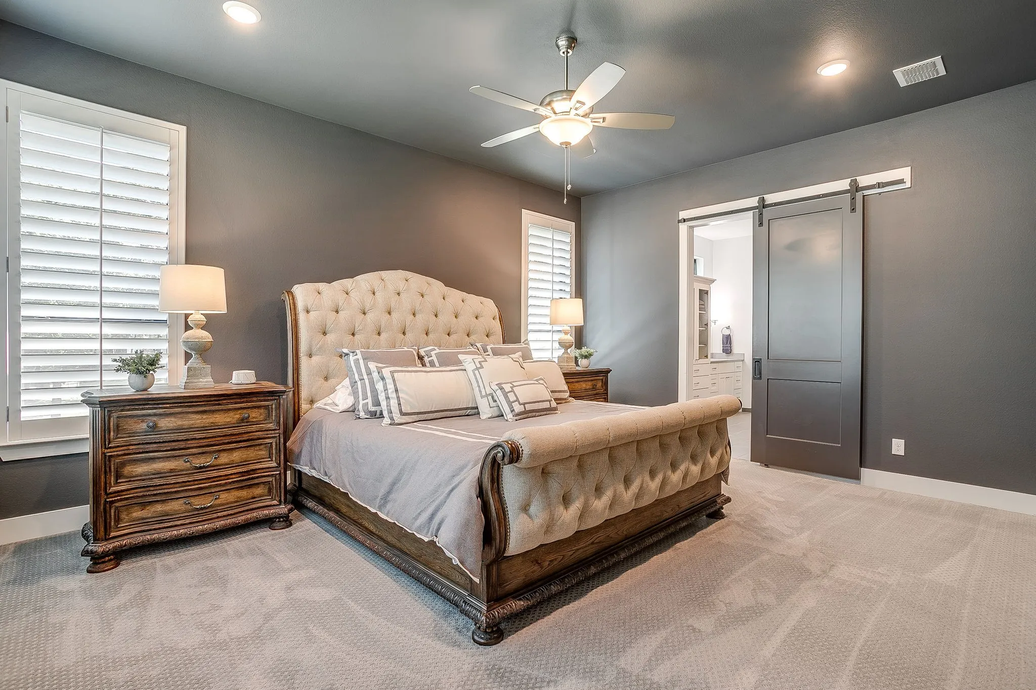 Large primary bedroom with sliding barn door leading to primary bath.