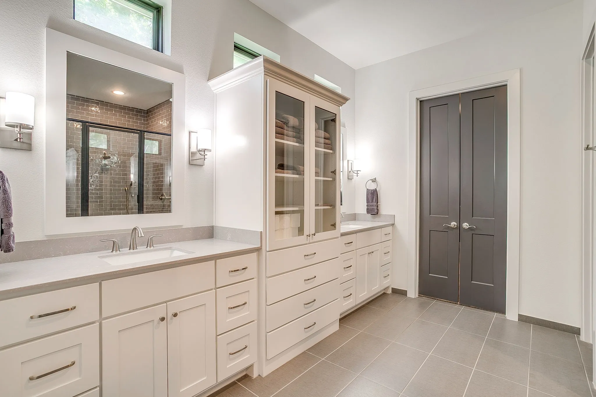 Primary bath with dual sinks & custom cabinets.