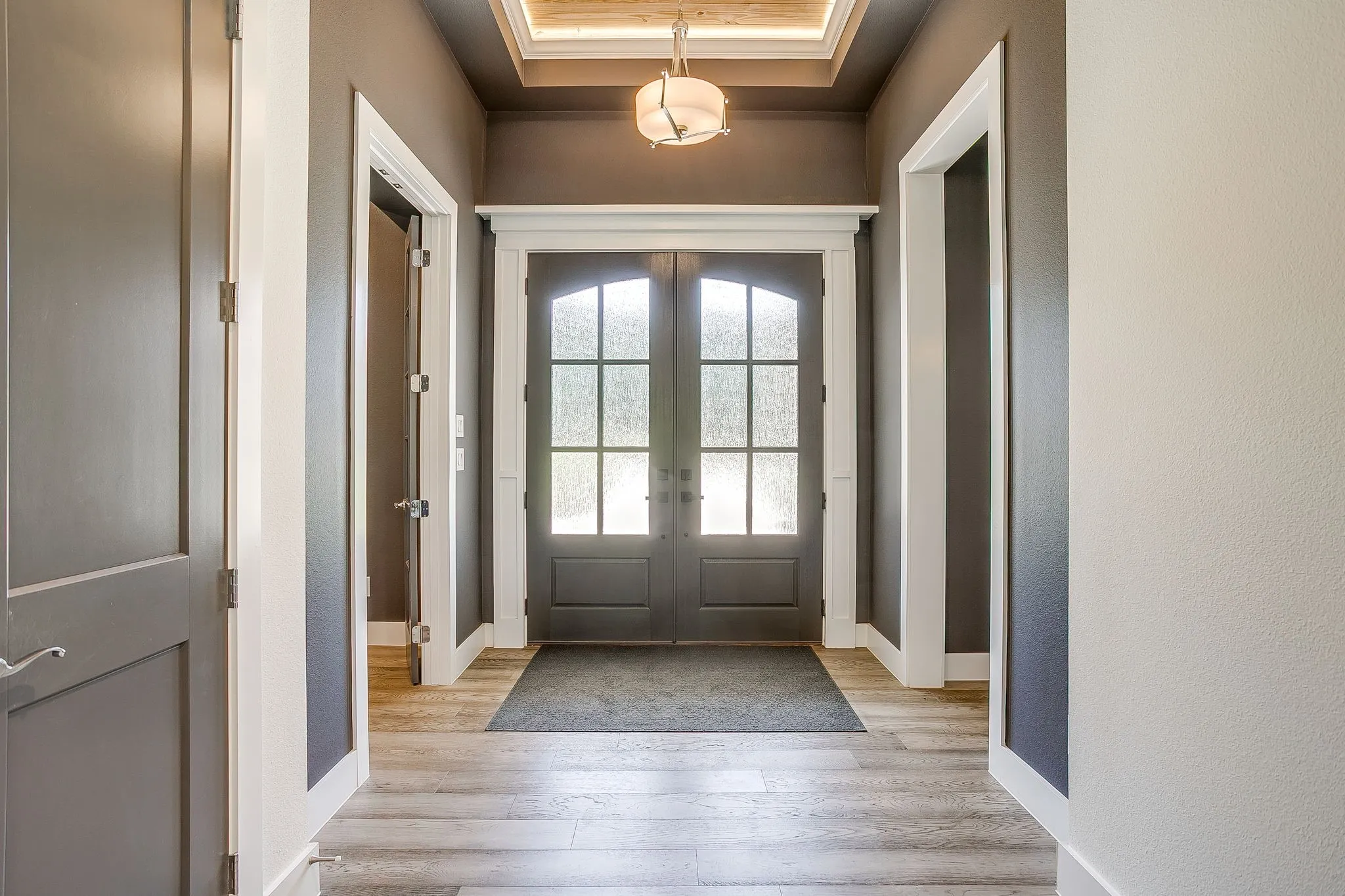 Large entryway with double front doors & extensive crown molding.