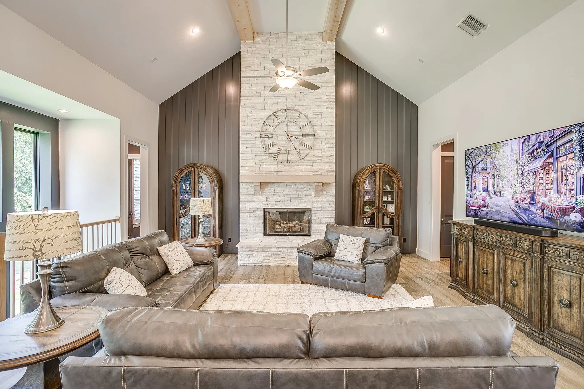 Living room with floor-to-ceiling, wood burning fireplace.