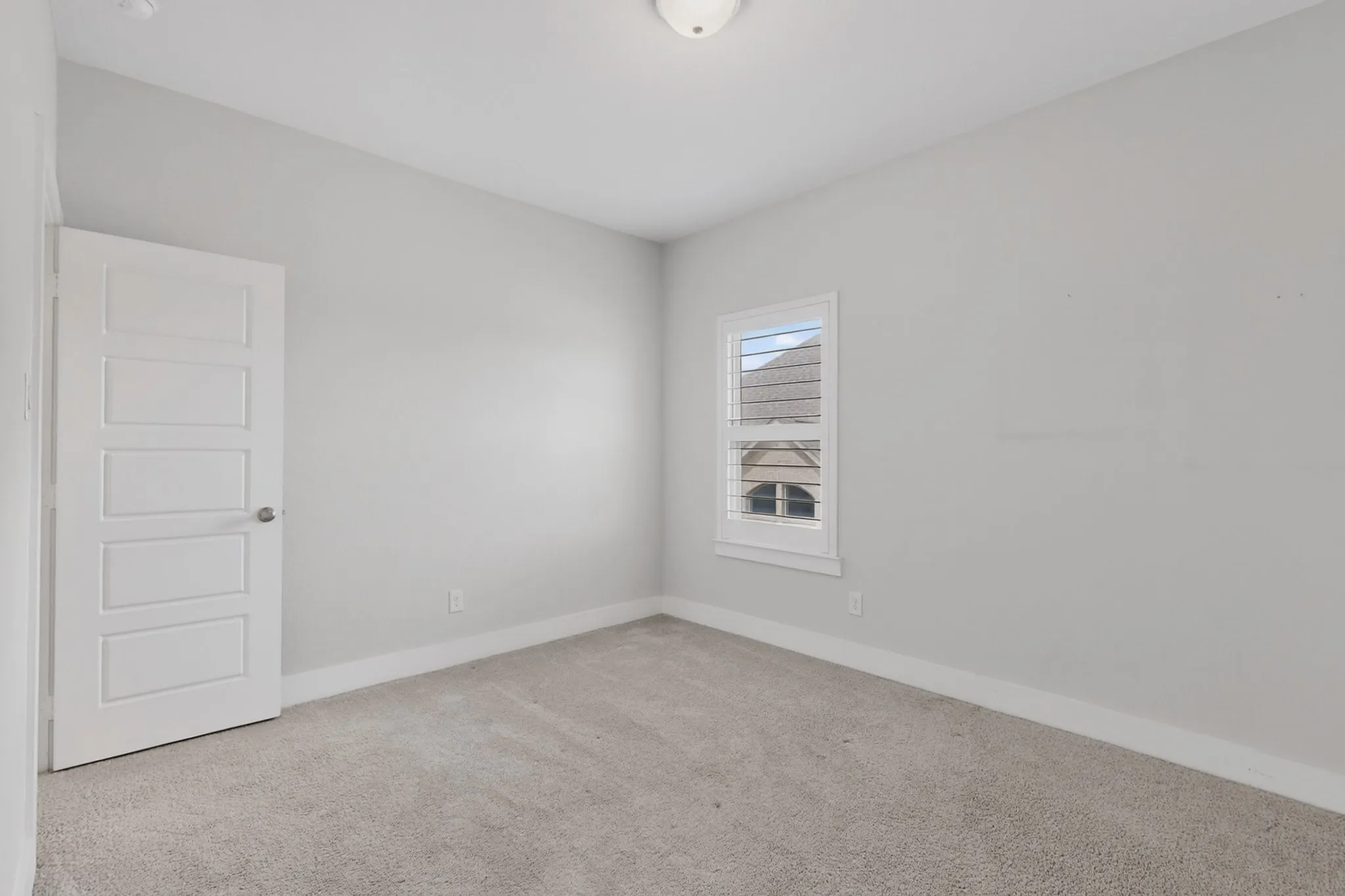 Neutral-toned wall paint and carpeting create a versatile interior space