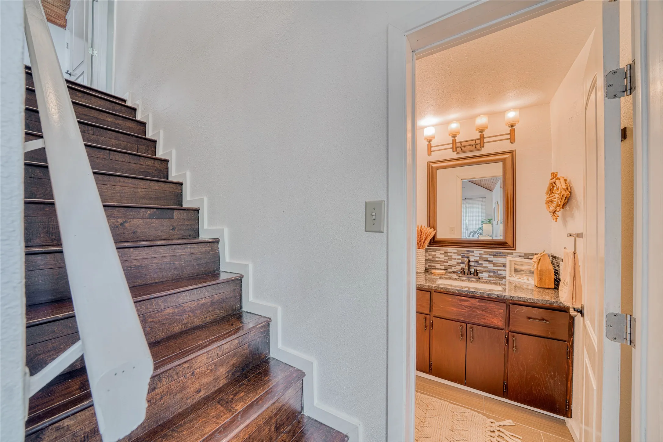 Wood-finish staircase with white risers and handrail