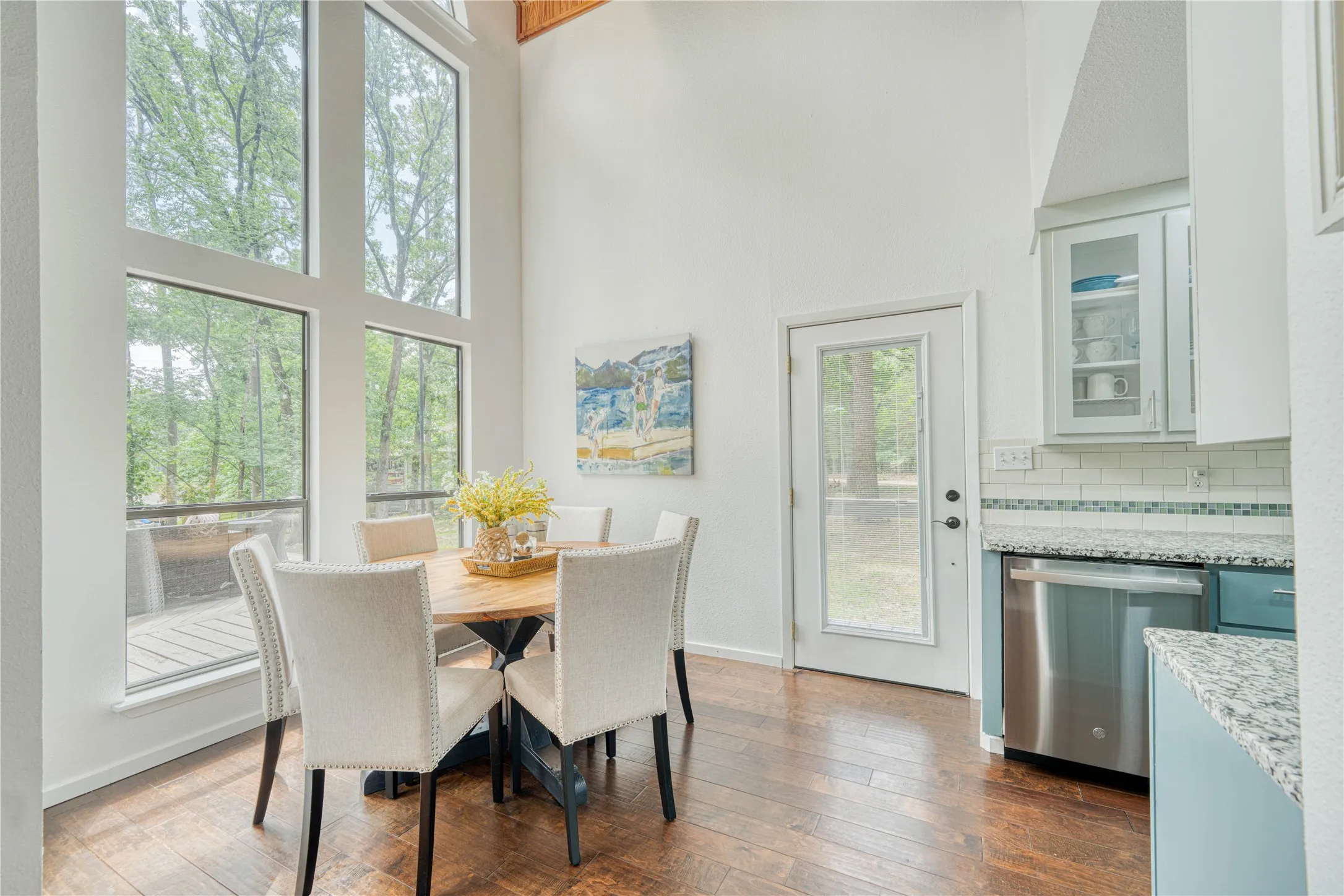 Dining area featuring a vaulted ceiling and large windows