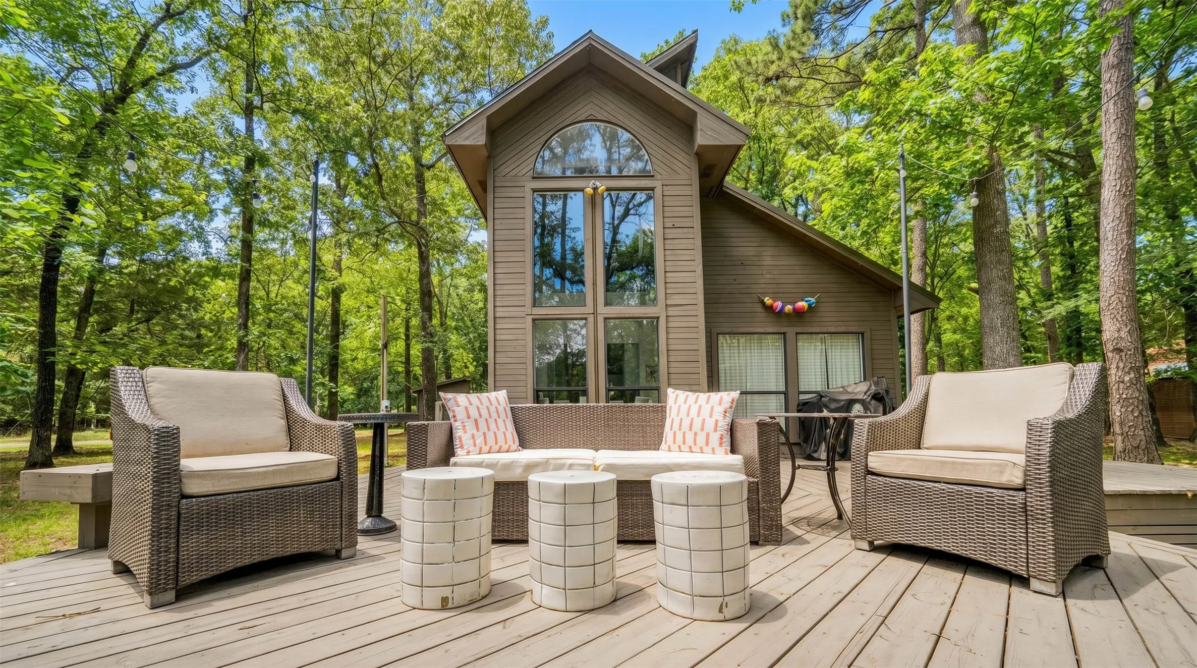 Spacious wooden deck extending from a contemporary-style home with vertical siding
