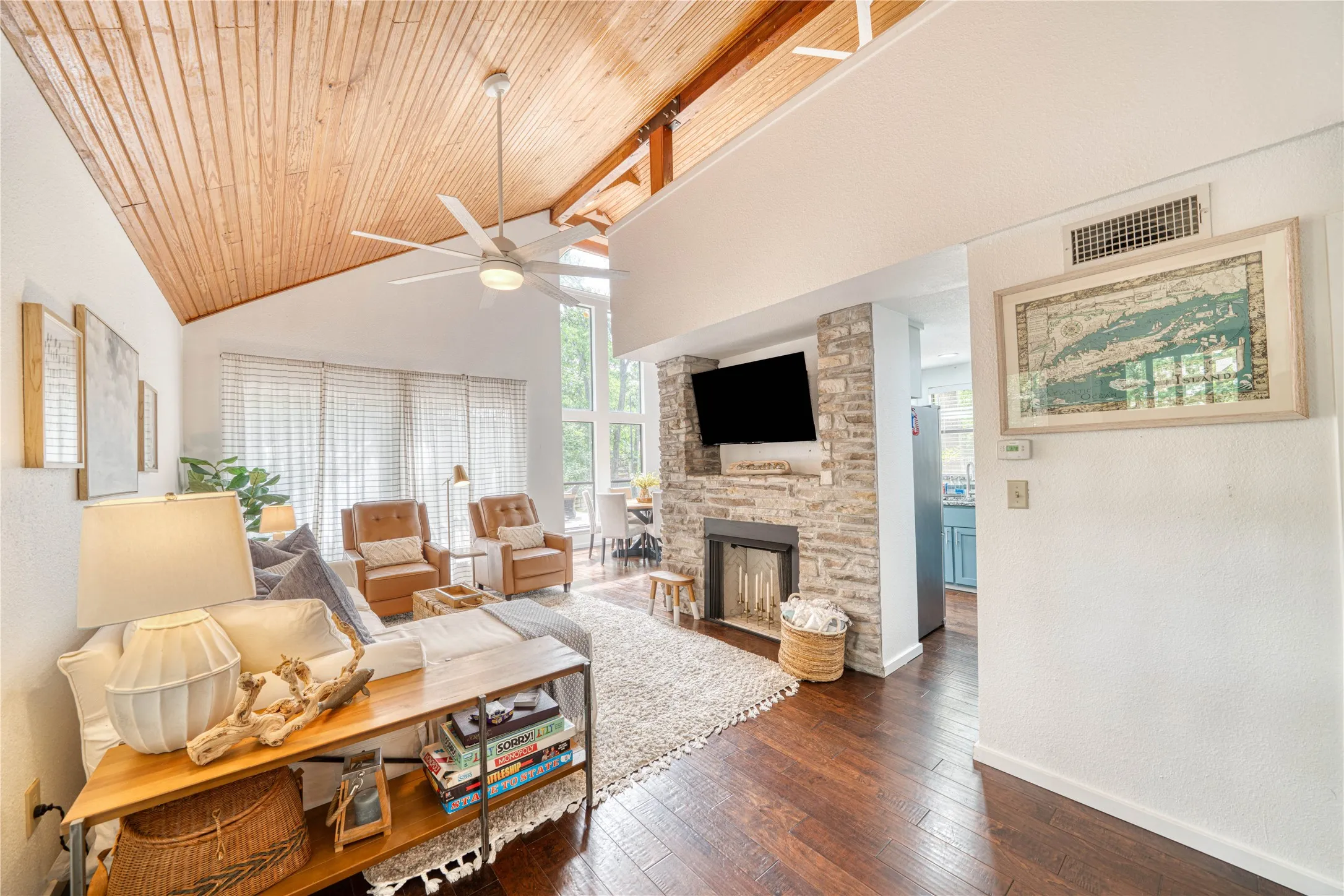 Vaulted ceiling featuring wood-finish paneling and exposed beams