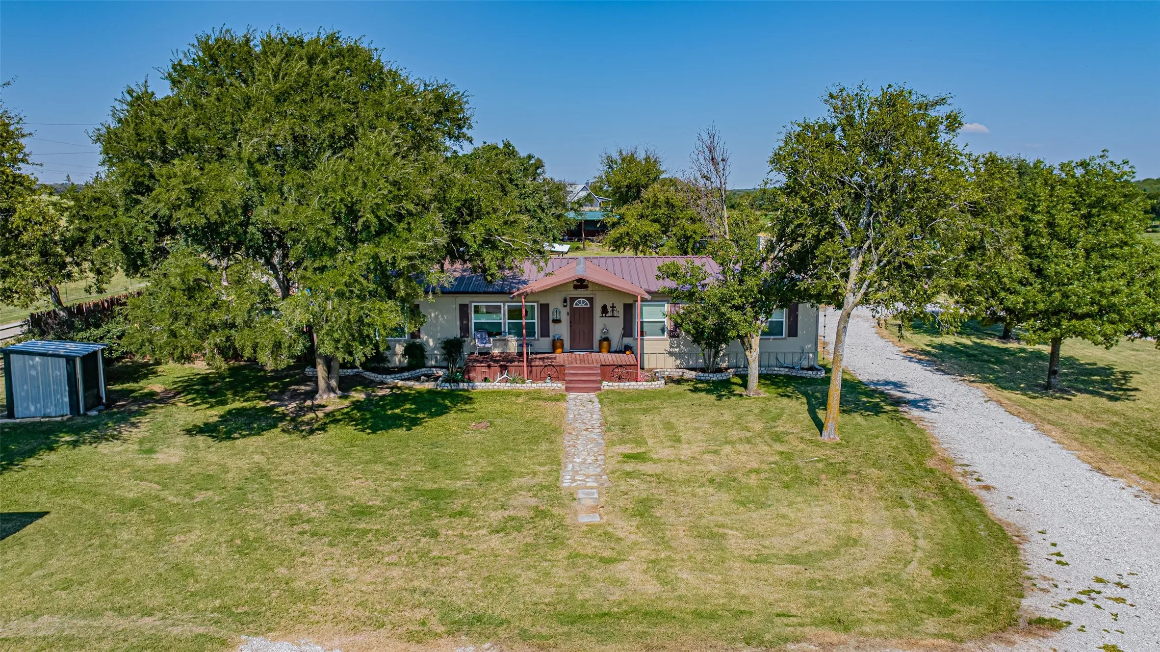 View of front of property featuring a porch, a front yard, and 2 car carport.