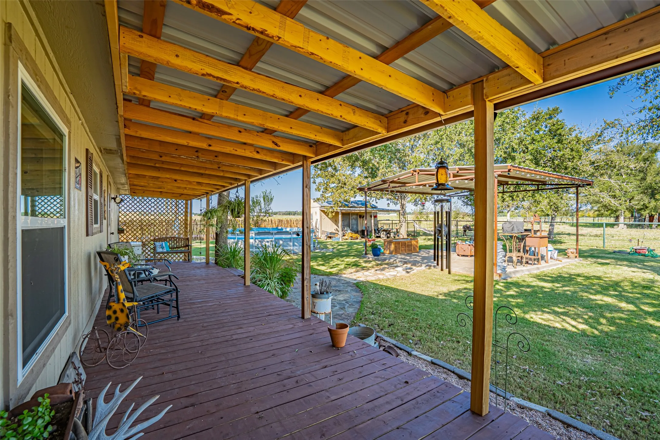 Wooden deck with a fenced backyard. Pool has been removed after pictures taken.