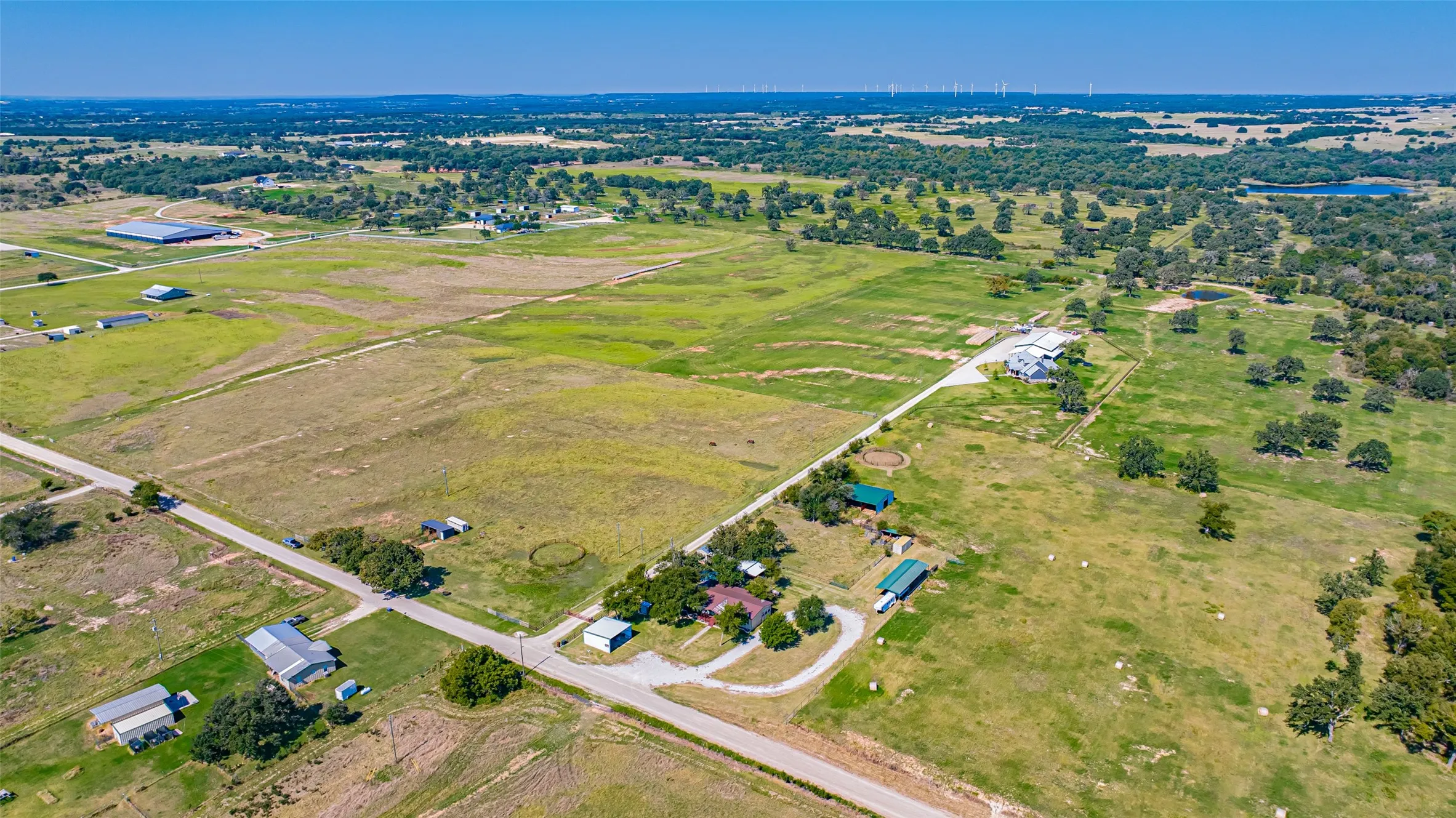 Aerial view of property and surrounding area featuring rural landscape.