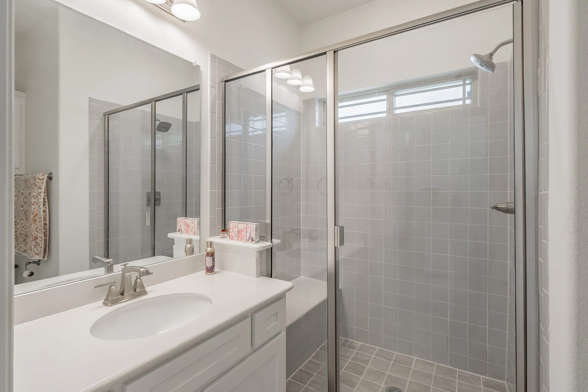 Bathroom featuring vanity and an enclosed shower