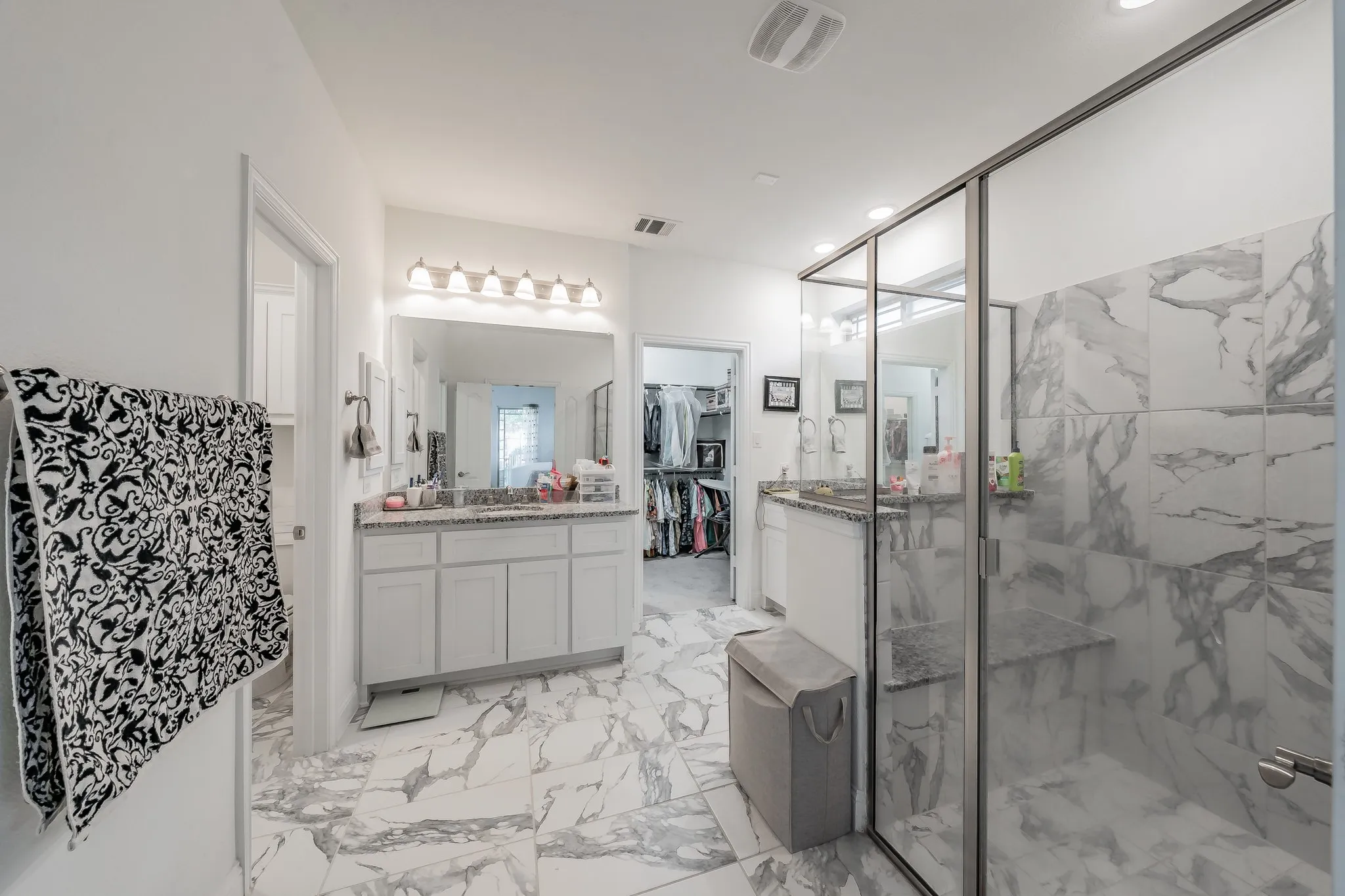 Bathroom featuring large walk in closet