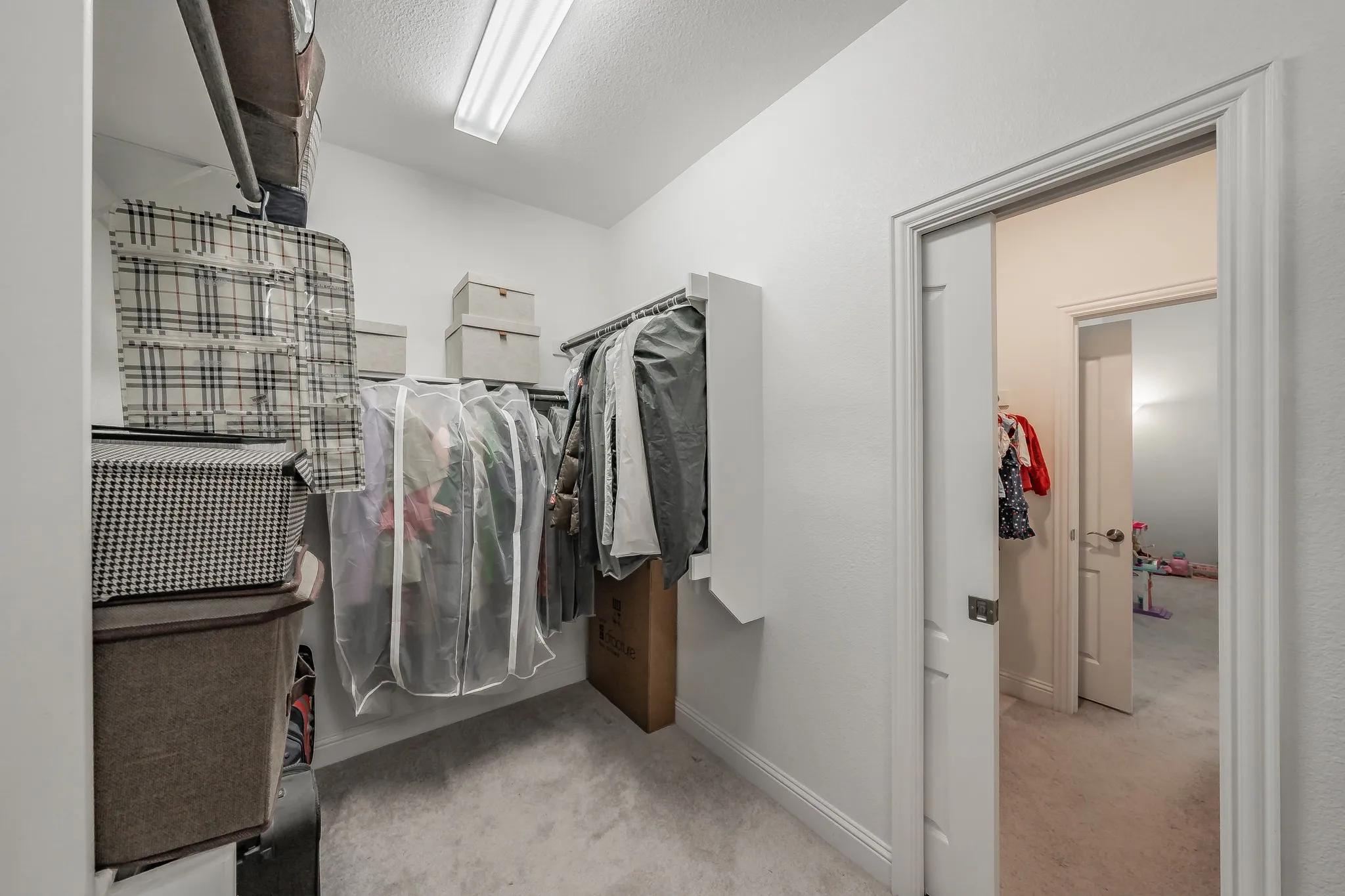 Pocket door in primary walk in closet enters bedroom #2 closet. This is a quick shortcut for their child!