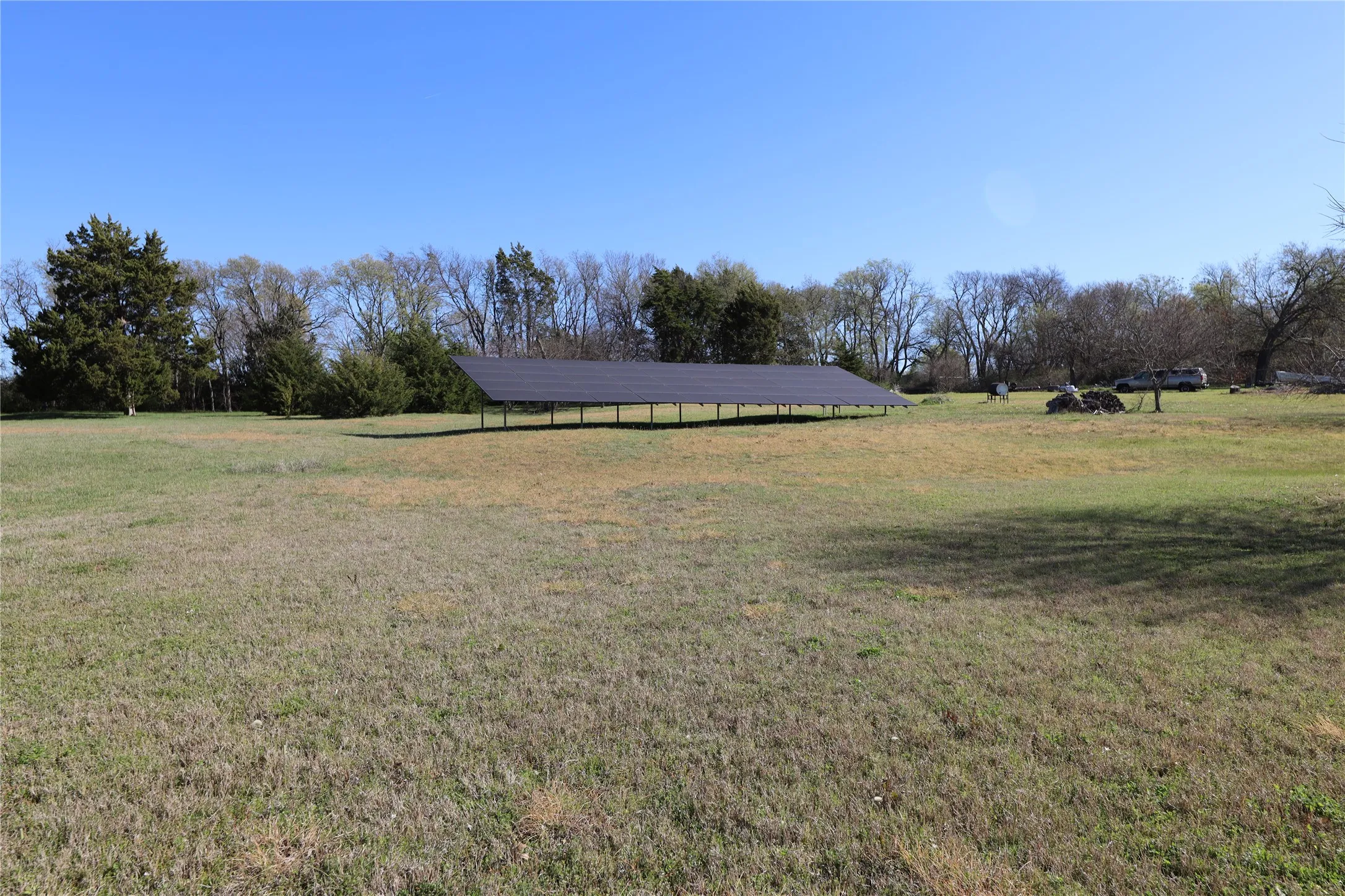 Expansive open field featuring a large ground-mounted solar panel array