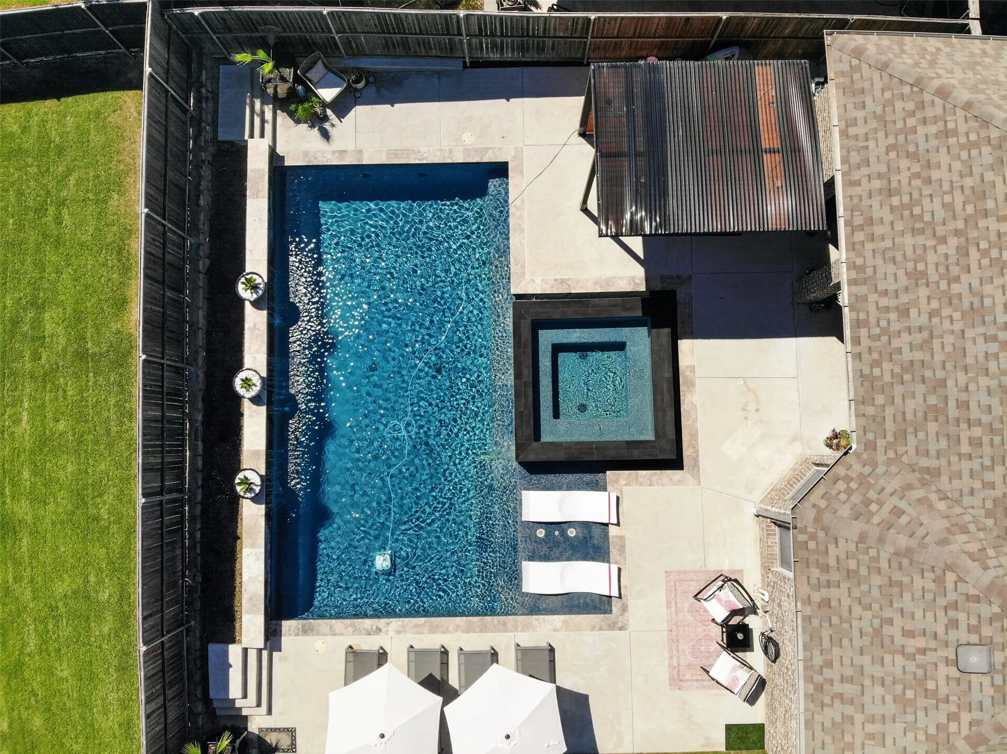 Overhead view showcases the pool, spa, sun shelf and surrounding deck.