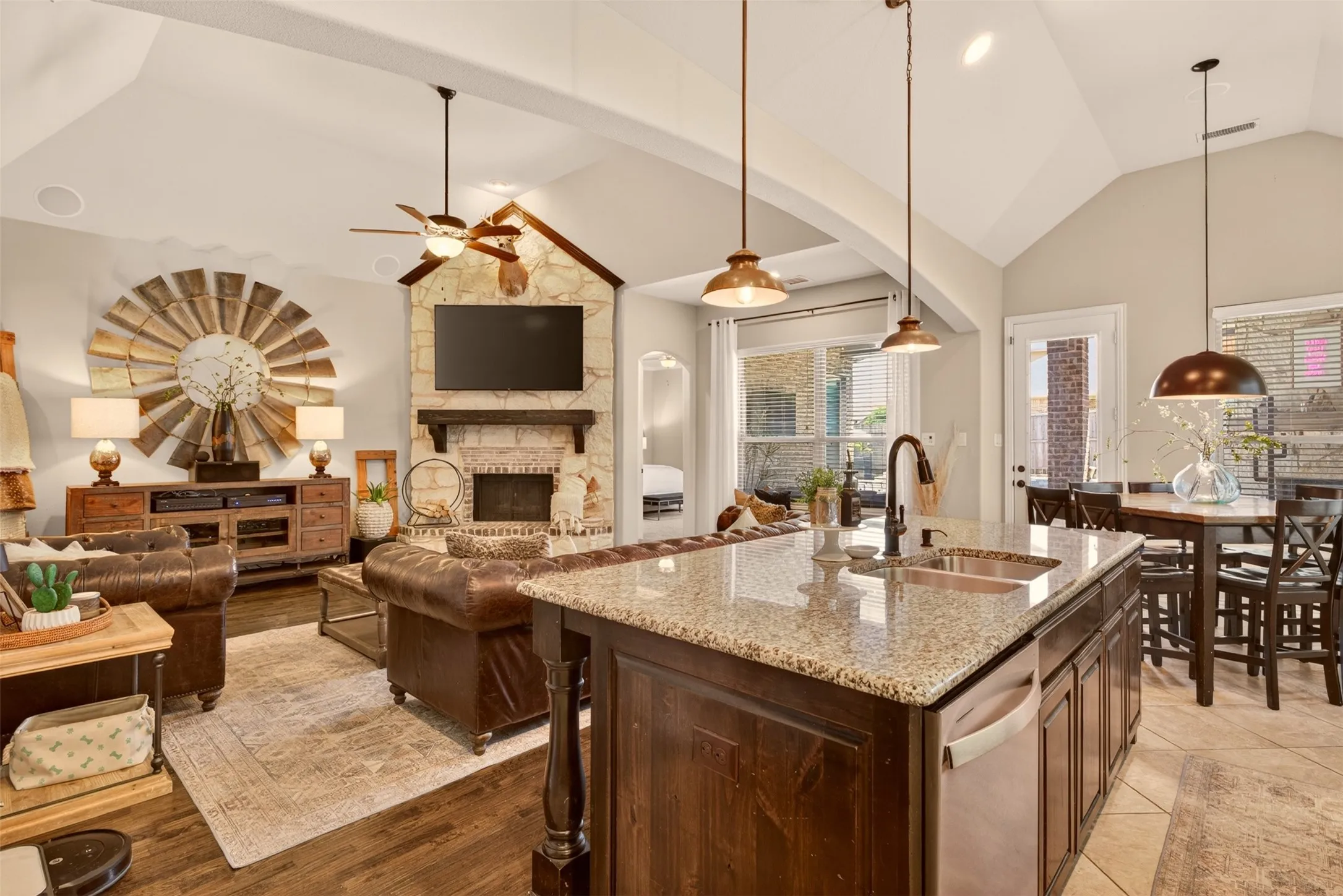 Open kitchen features a large island, pendant lighting and generous workspace for everyday living.