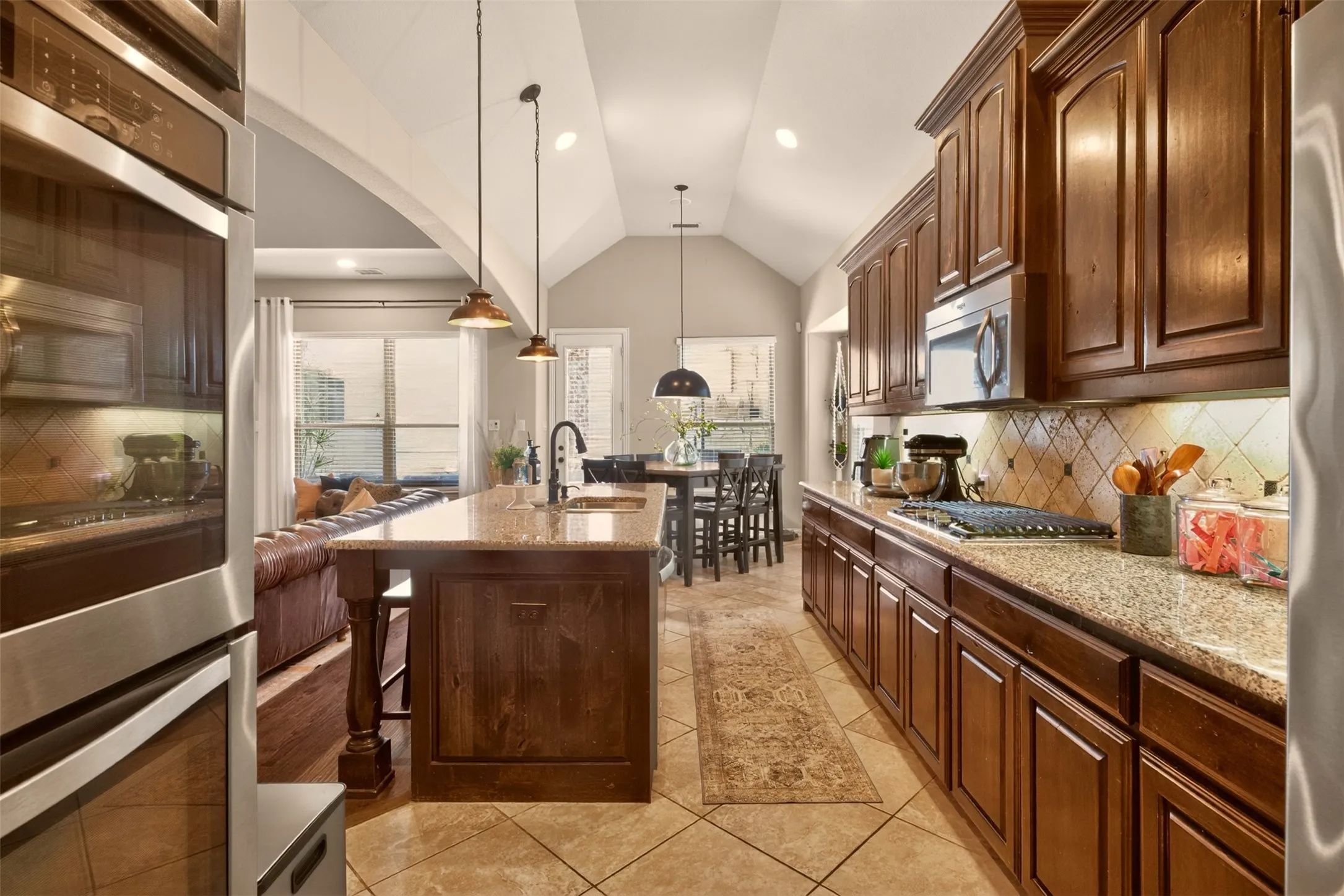 Rich cabinetry, double ovens and extensive counter space create a functional kitchen for cooking and entertaining.