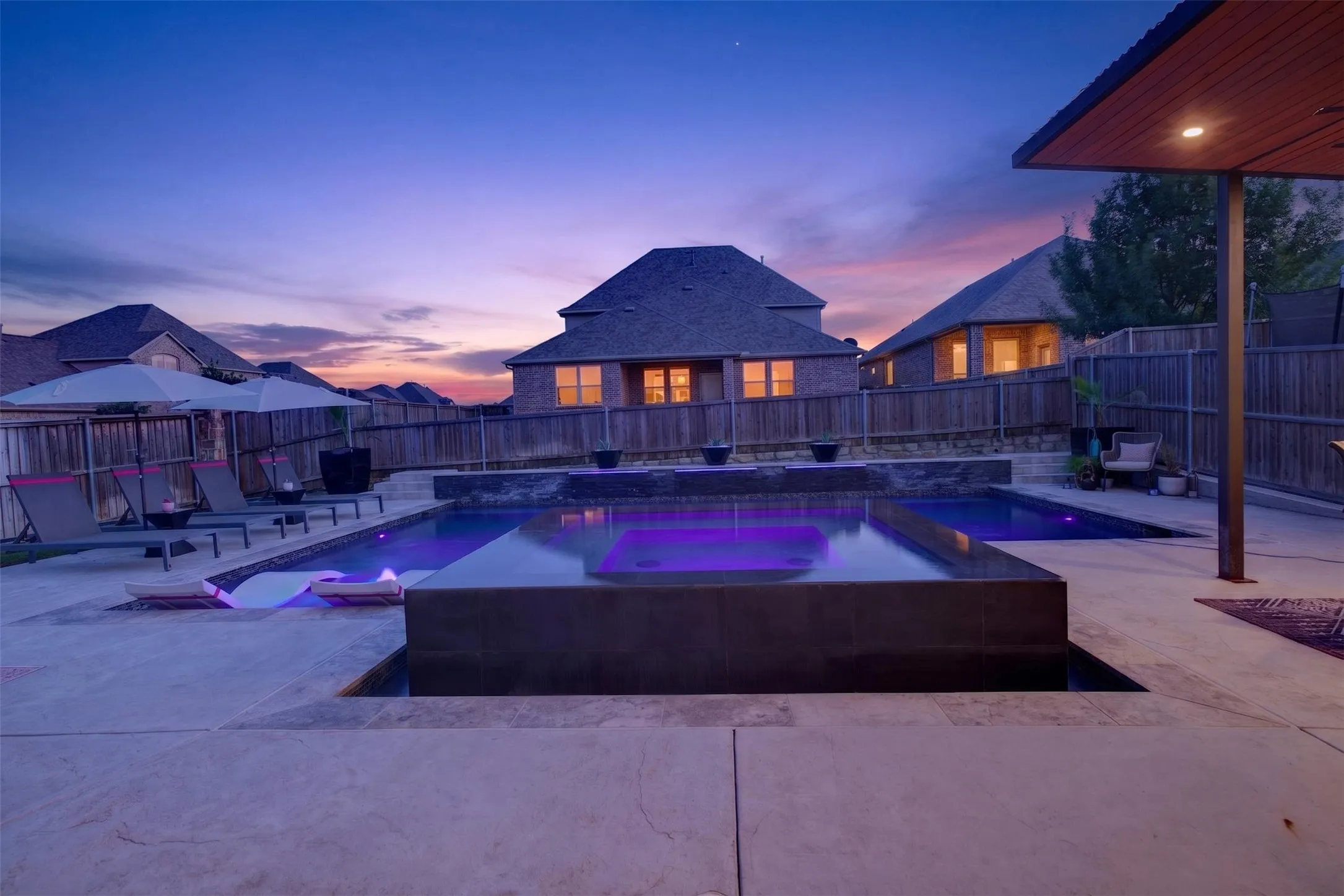 Expansive pool deck offers multiple areas for lounging, dining and entertaining.