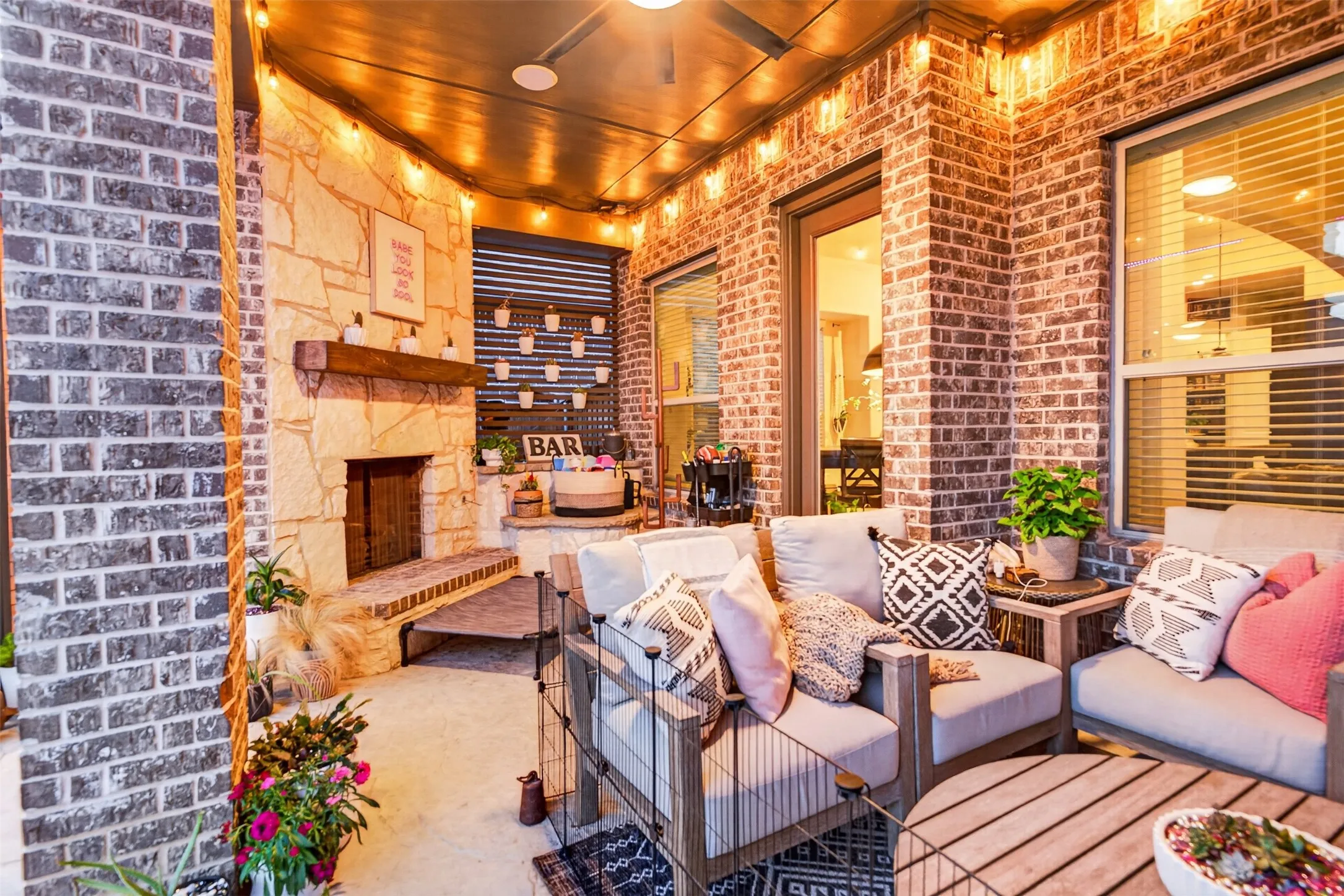 Outdoor fireplace and comfortable seating make the covered patio an inviting extension of the home.