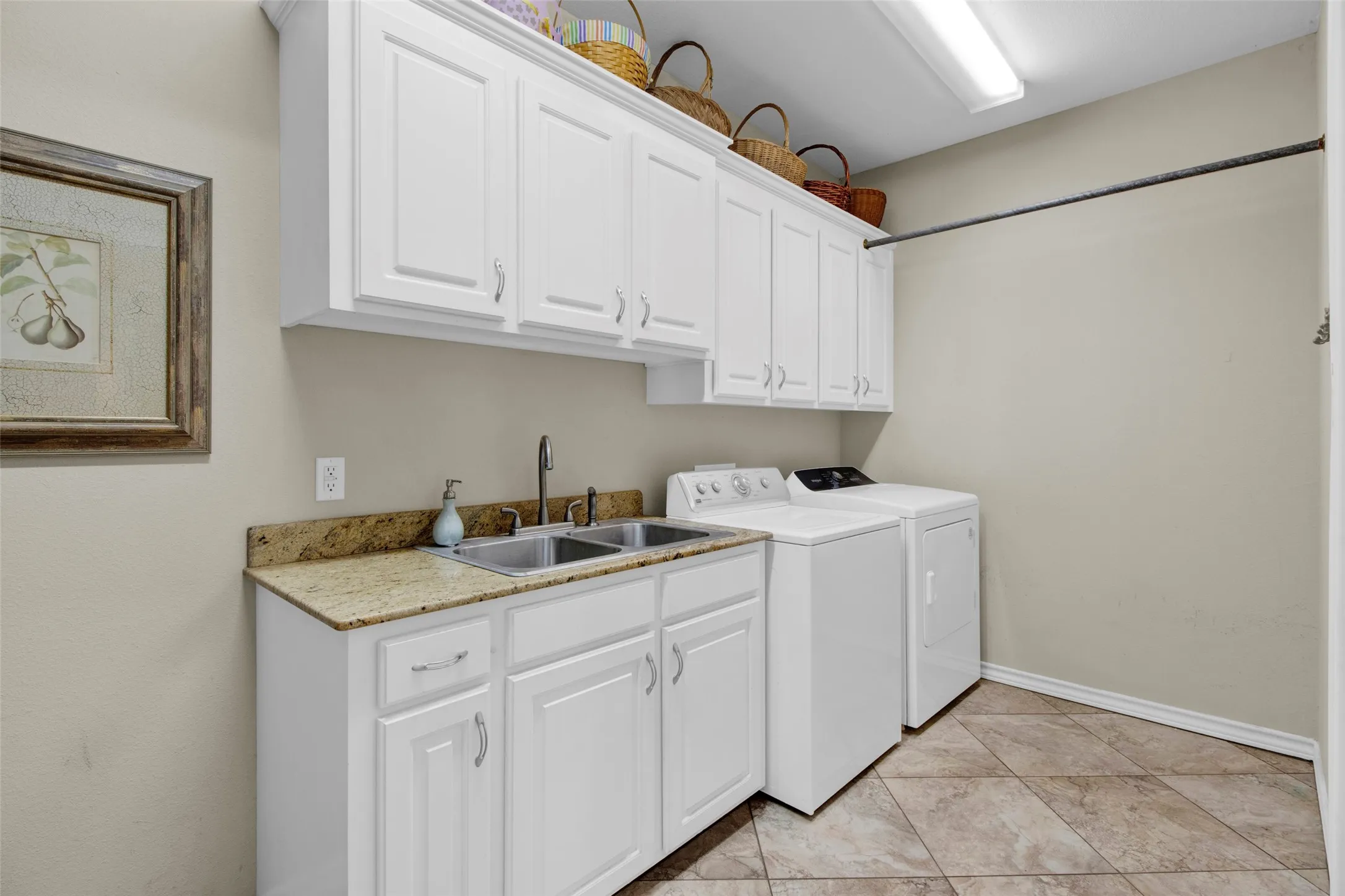 Enter the Laundry/Utility Room either from Primary Closet OR Hallway and space to do all your laundry needs - Stow away ironing board is a space saver. You will love this room!