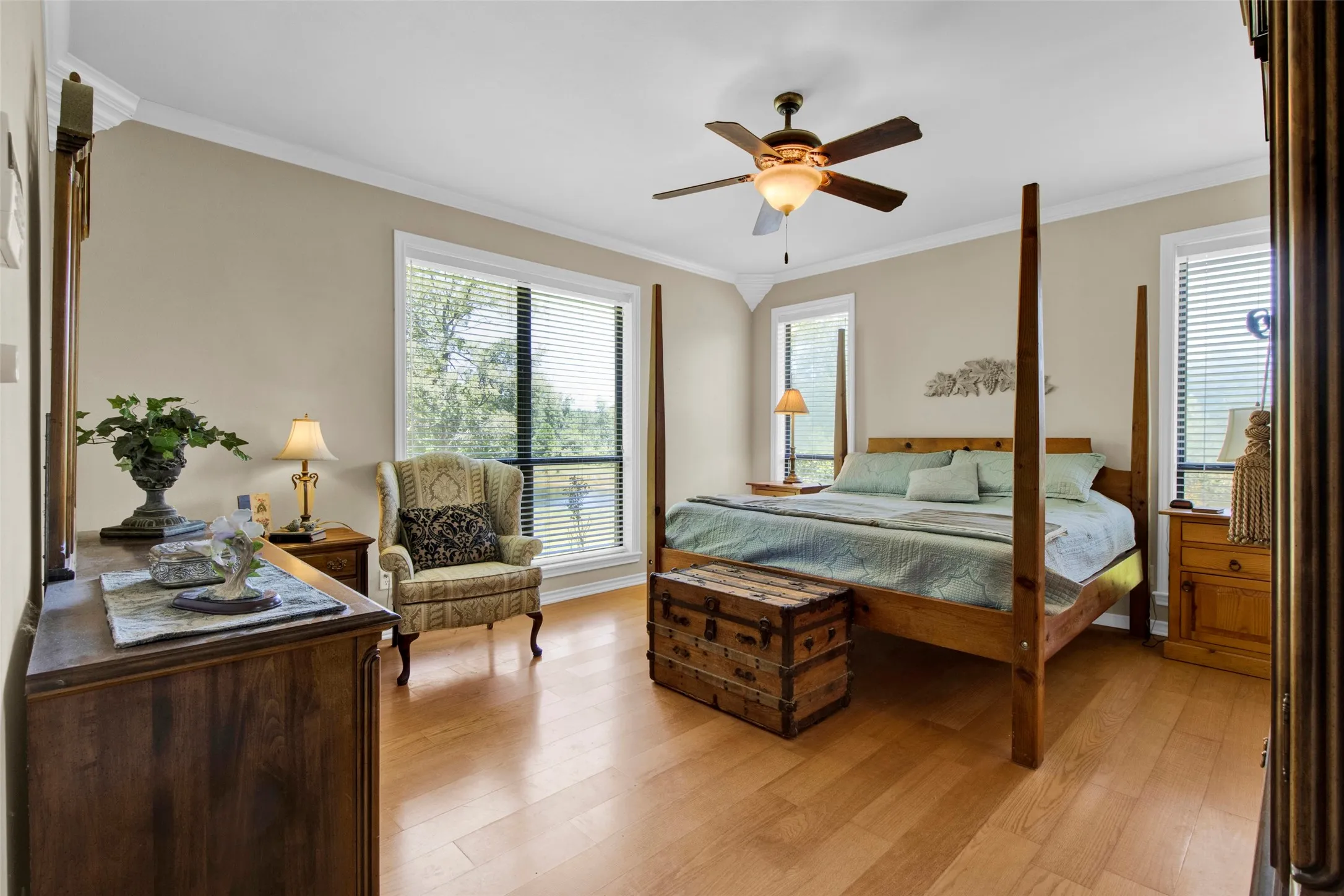 Primary is located on its own side of the house offering as much privacy as you want - Wood flooring, ceiling fan, views  -