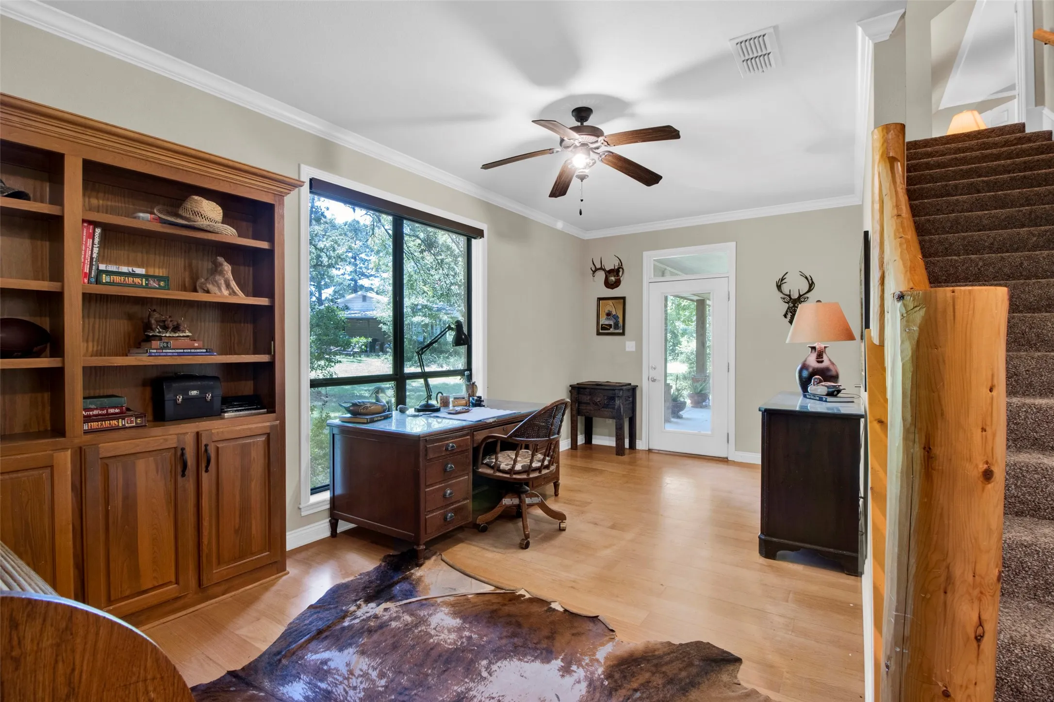 Hardwood-finish flooring complementing a built-in wooden bookcase with lower cabinetry