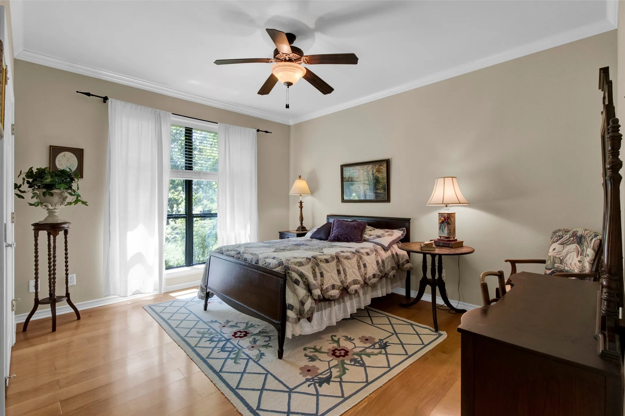 #2 Bedroom with Light wood flooring with crown molding and a ceiling fan with light fixture, blinds, and sufficient closet space