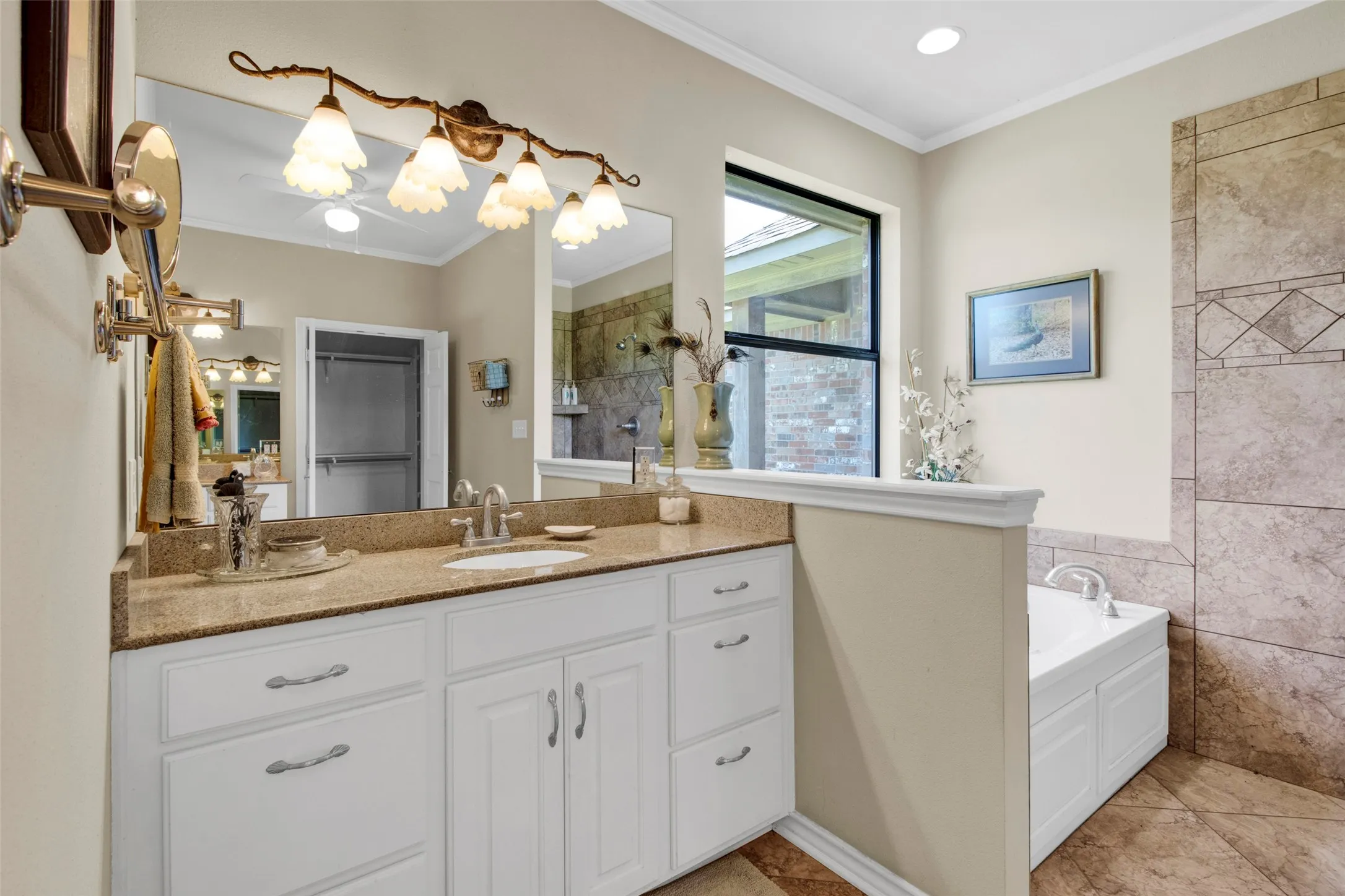 Primary Bath with two vanity sinks, soaking tub, and tiled shower