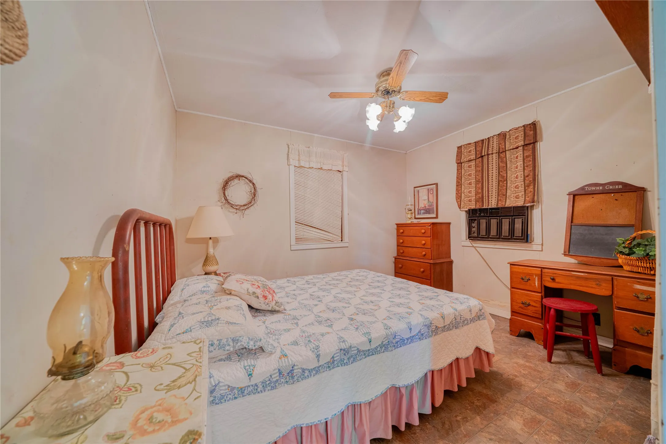 cottage Bright interior space featuring a ceiling fan with light fixture, wood-finish flooring, and white walls