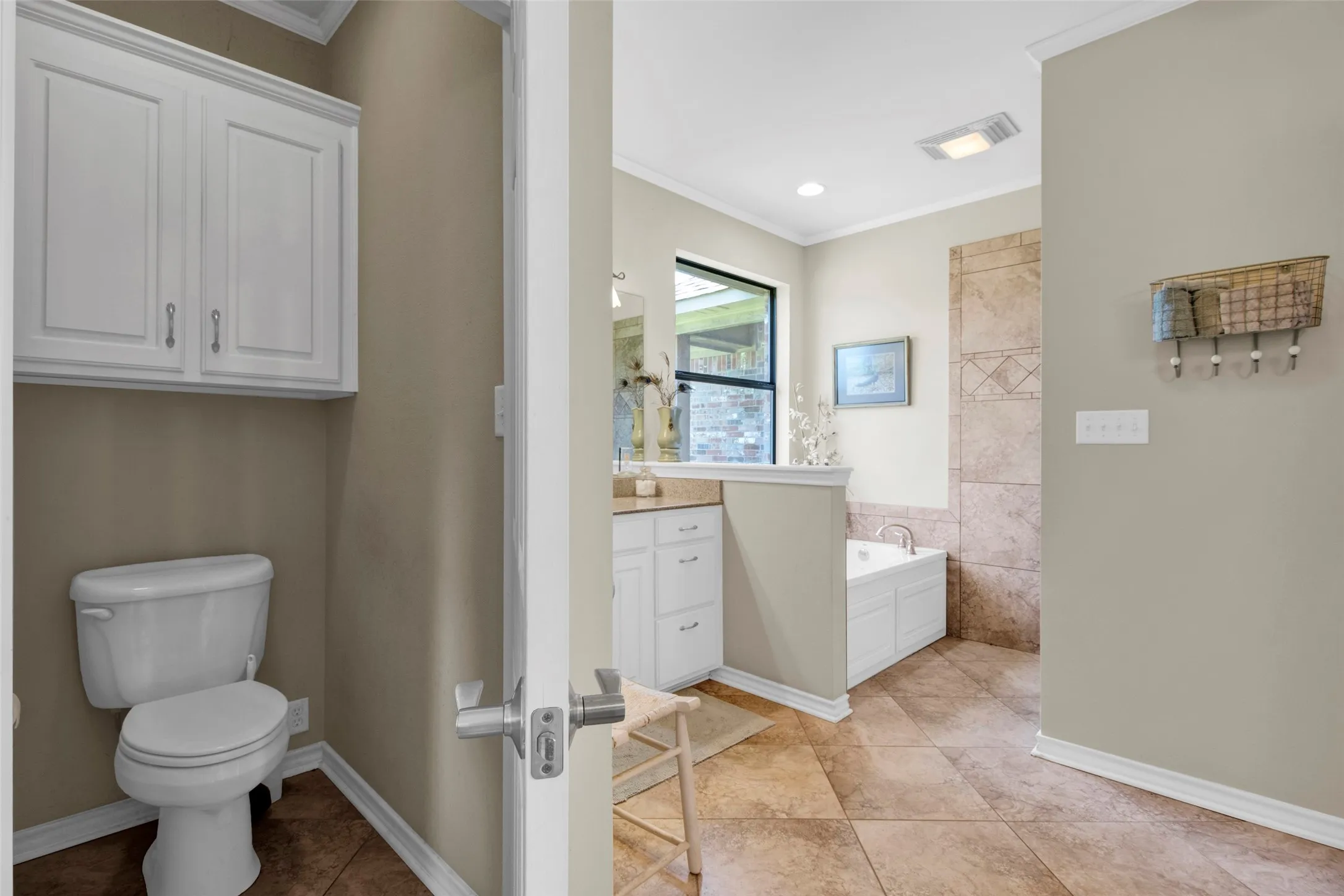 enter the Primary Bath through double doors with your private WC, soaking tub, 2 separate vanities, all accessible showers and fabulous walk-through Closet