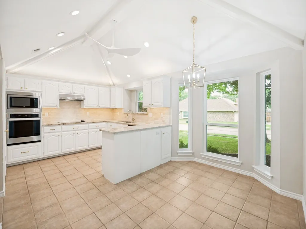 Kitchen featuring a vaulted ceiling, recessed lighting, and a modern ceiling fan