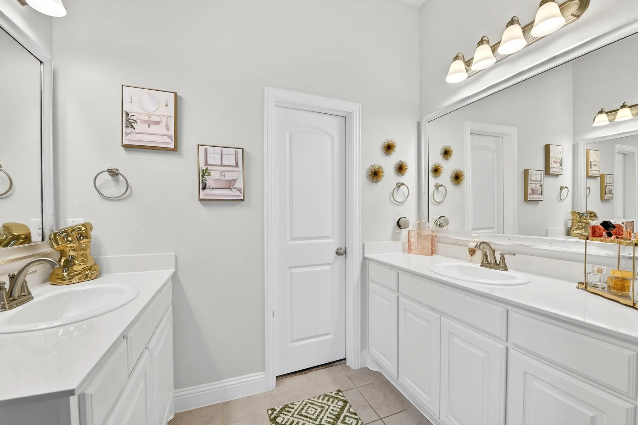 Dual vanities featuring white shaker-style cabinetry, white countertops, and undermount sinks