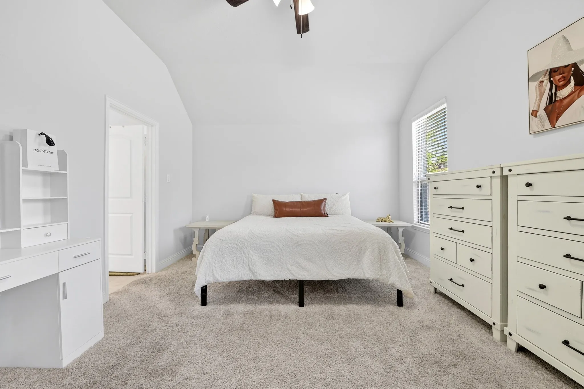 Room featuring vaulted ceilings, light gray carpeting, and a window with blinds