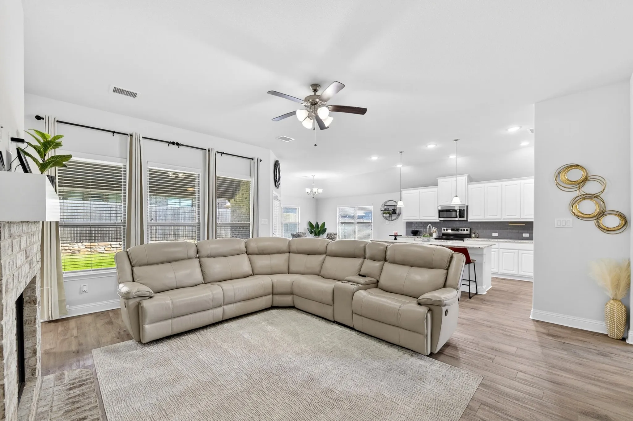 Open-concept living area featuring wood-finish flooring and a ceiling fan