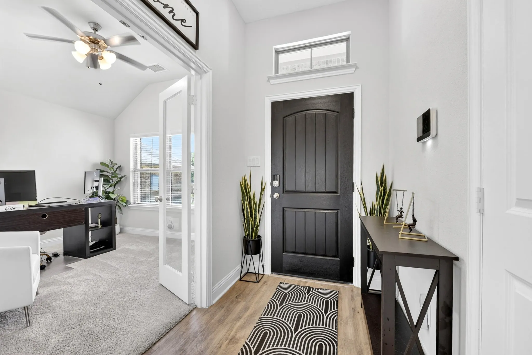 Arched paneled entry door with transom window