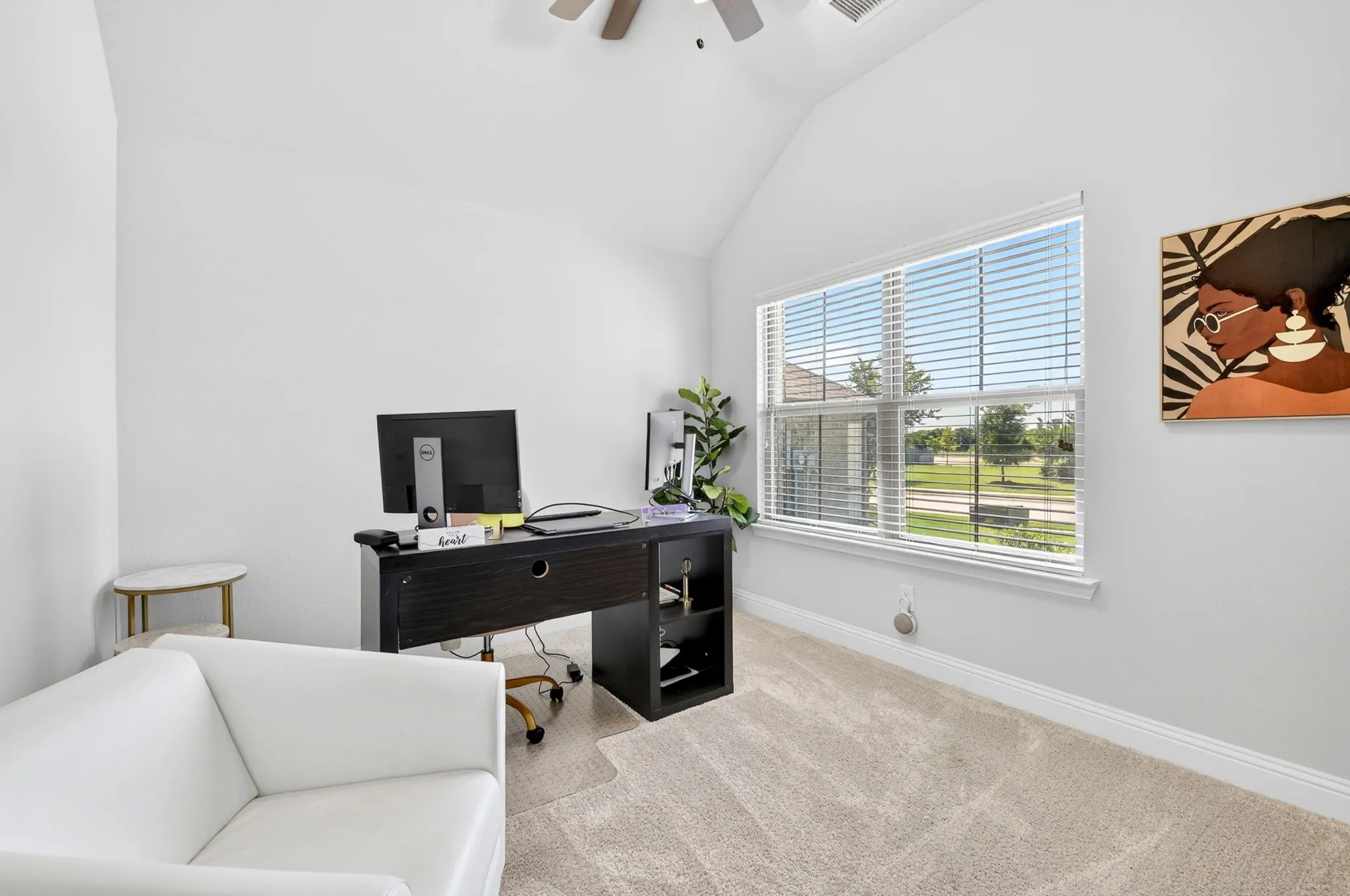 Room with vaulted ceilings and neutral carpeting