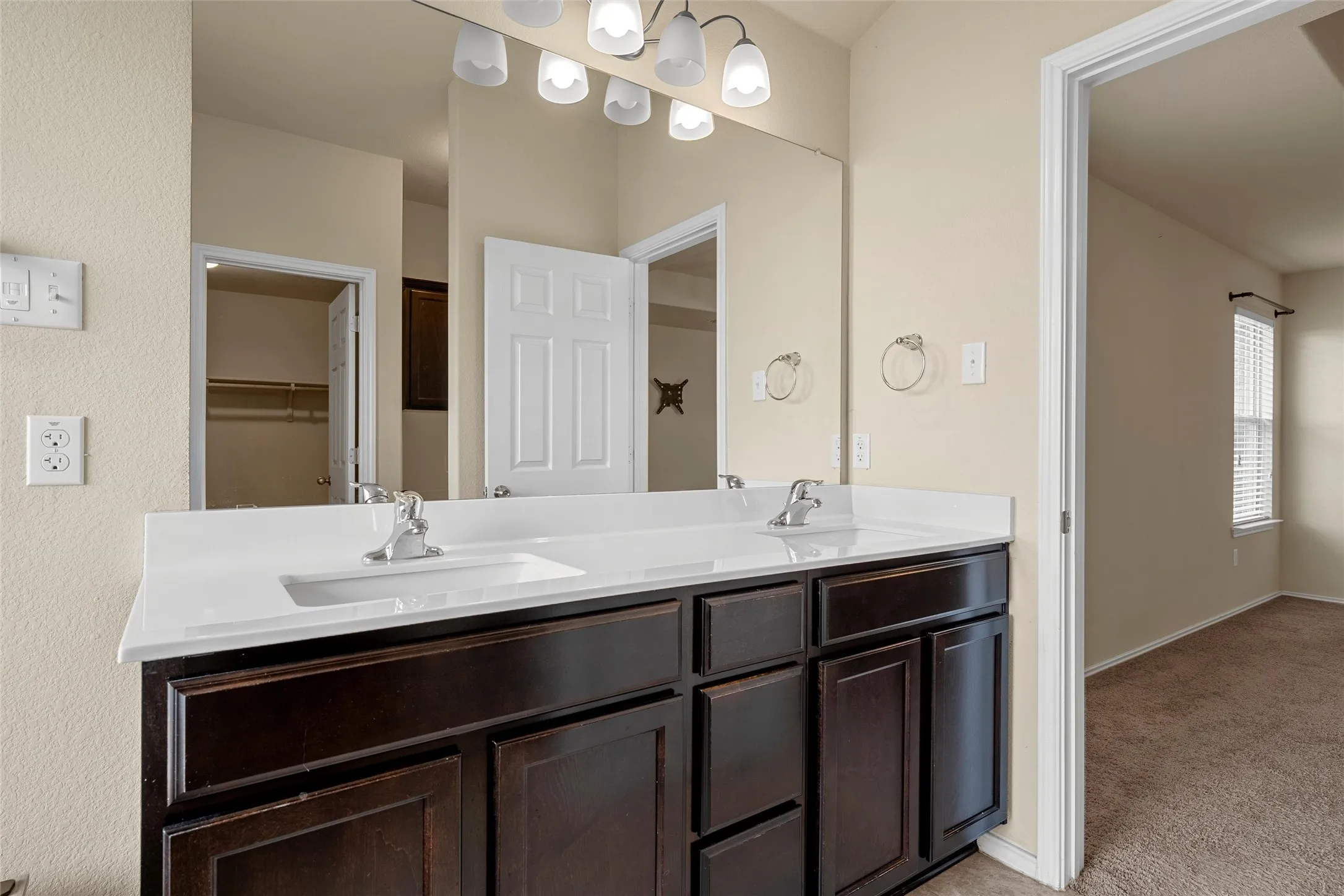 Double vanity featuring integrated sinks and chrome fixtures