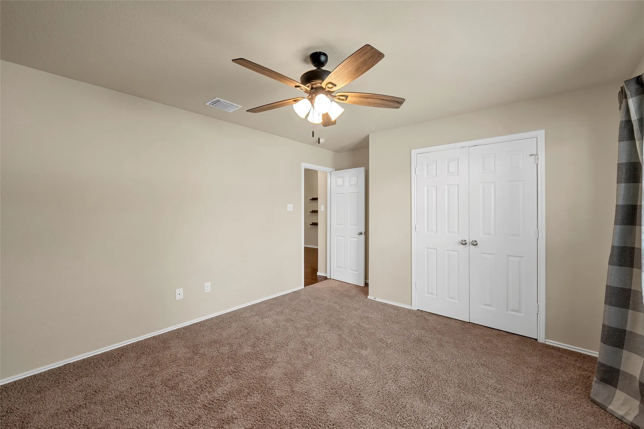 Carpeted room with neutral wall tones