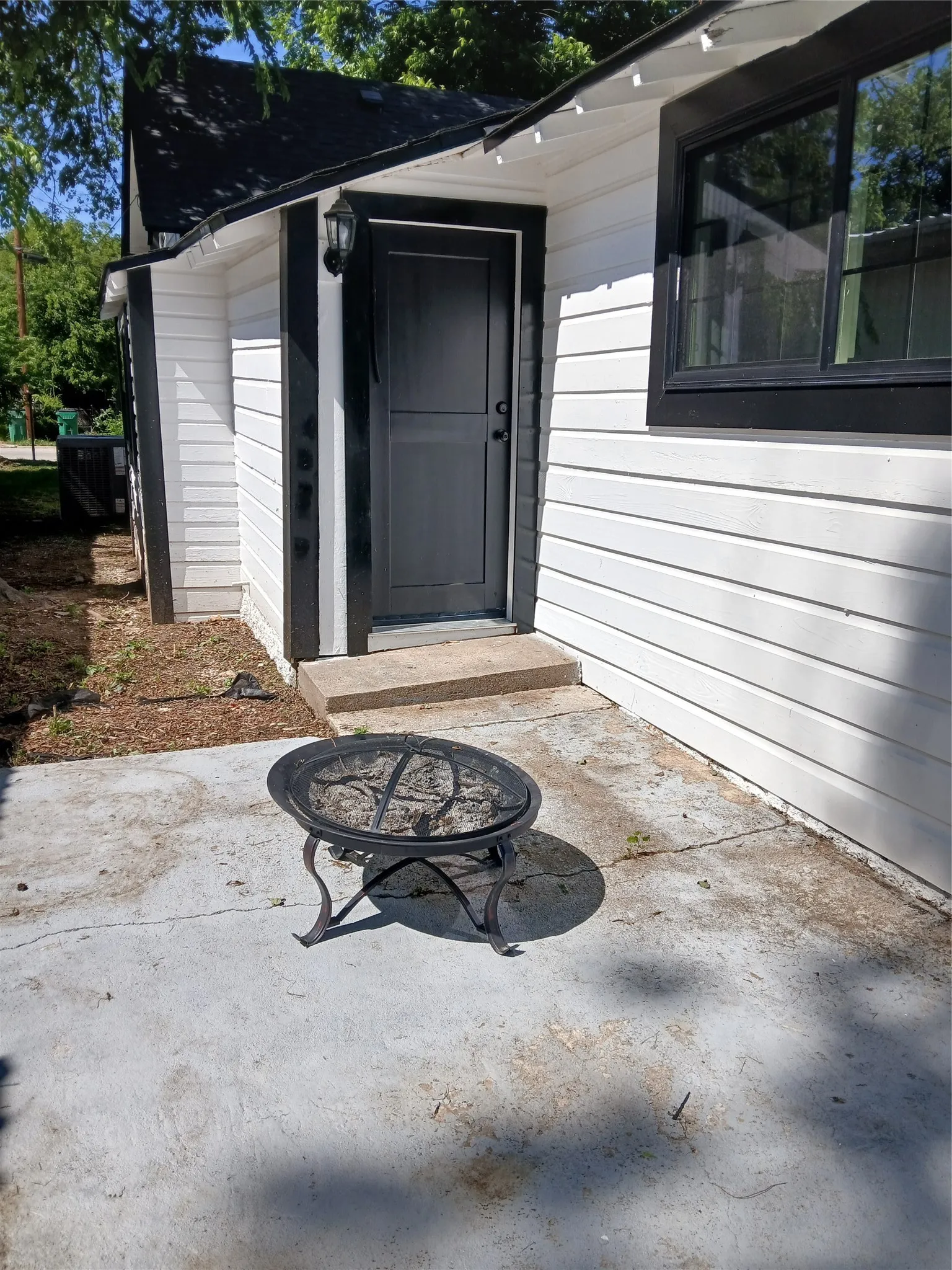 Back patio with entry to office area at back of home