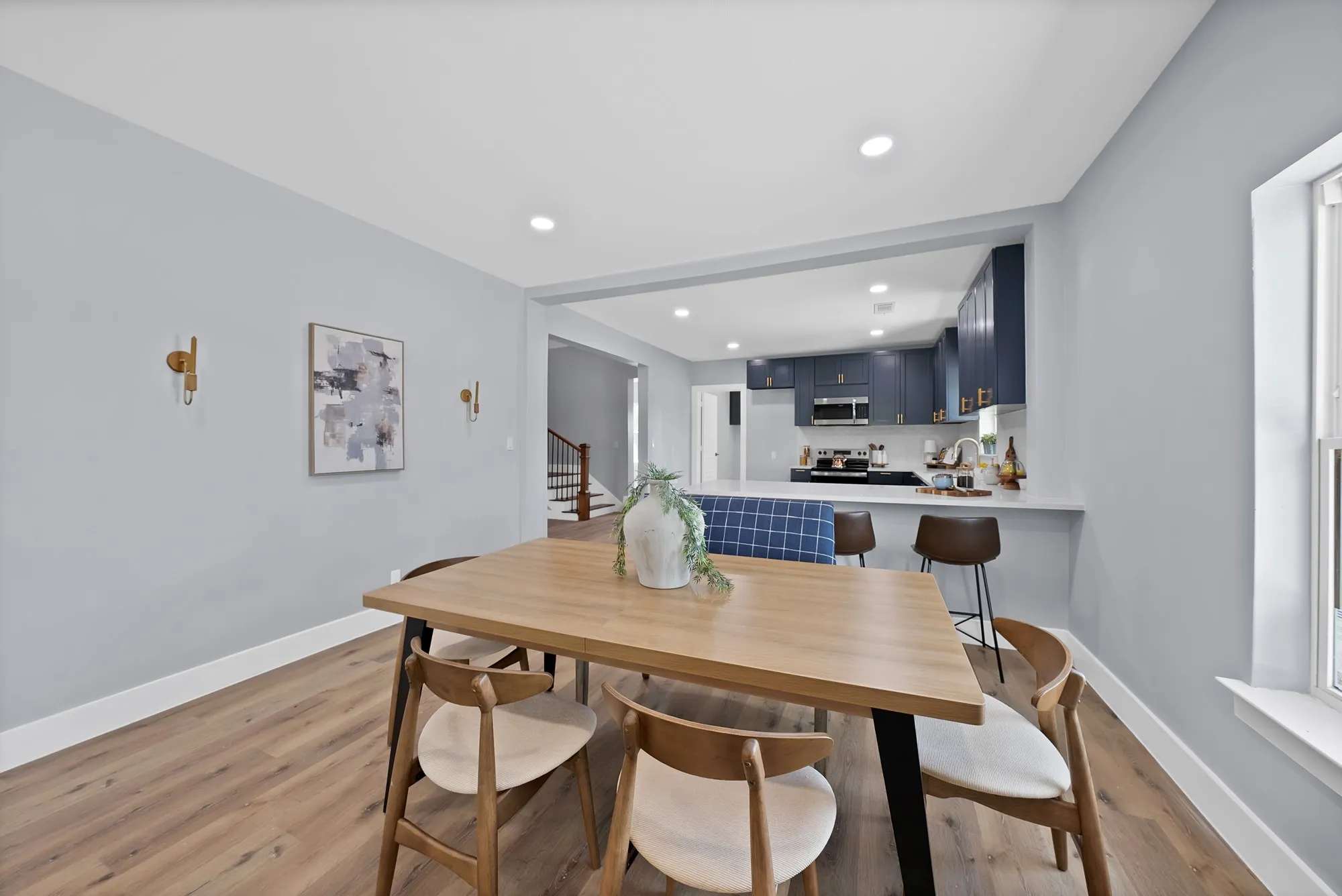 Dining area featuring wood-finish flooring and recessed lighting