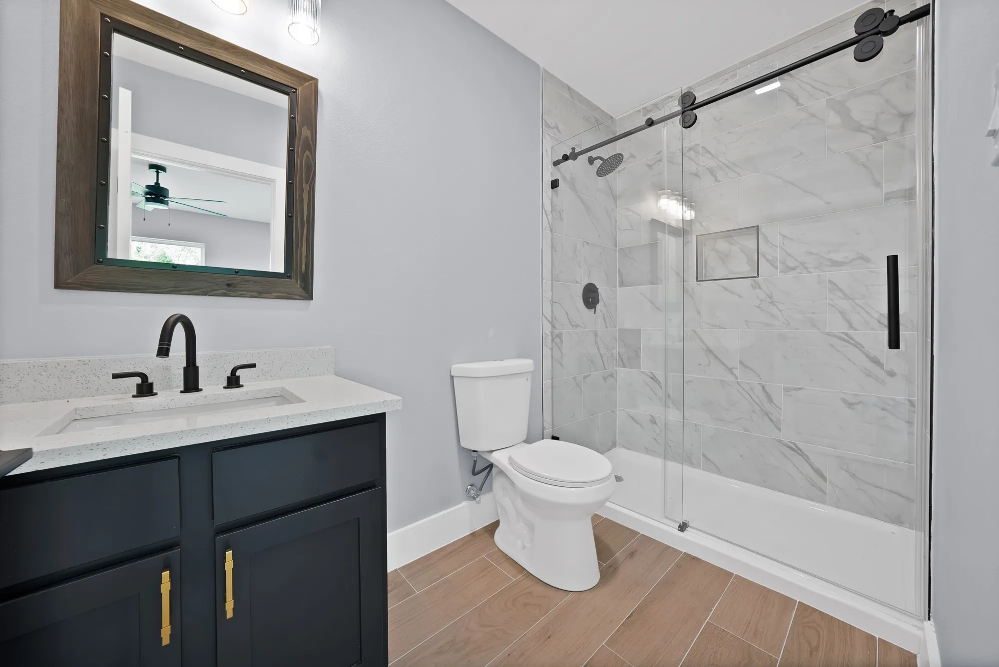 Bathroom featuring wood-finish flooring